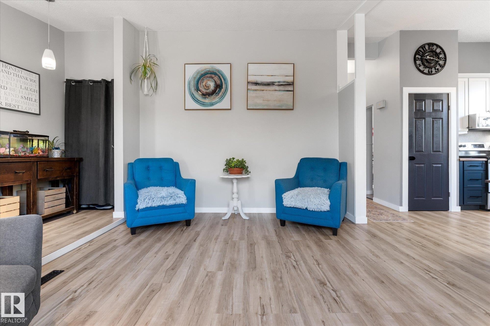 Spacious room featuring light wood-finish flooring, light gray walls, and white baseboards - 4759 48 Street, Onoway, AB - Indoor