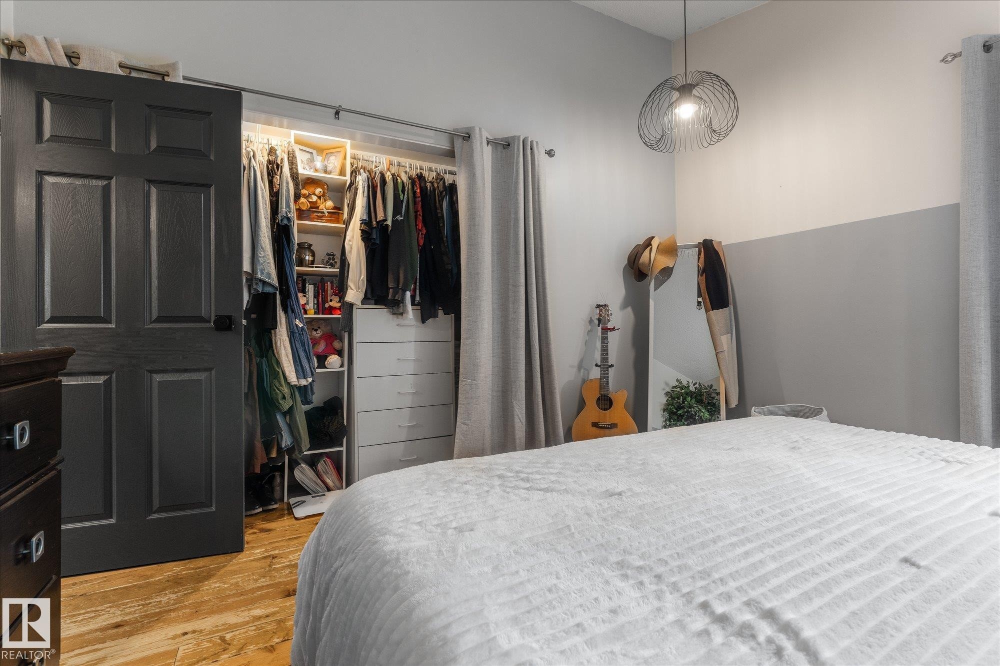 Custom closet system featuring built-in shelving, hanging rods, and integrated drawers - 4759 48 Street, Onoway, AB - Indoor Photo Showing Bedroom