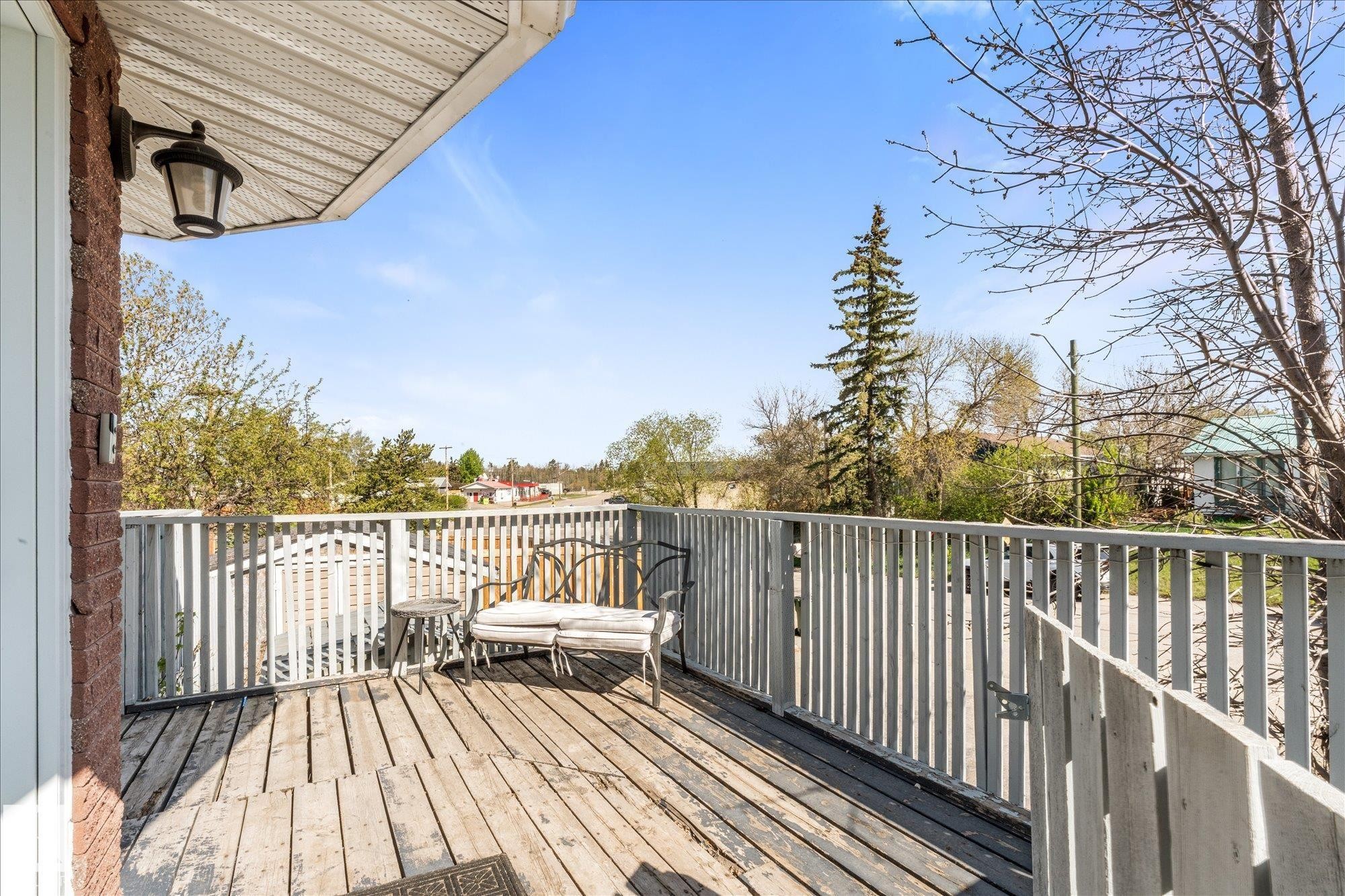 Expansive outdoor deck with wood flooring and vertical slat railing - 4759 48 Street, Onoway, AB - Outdoor With Deck Patio Veranda With Exterior