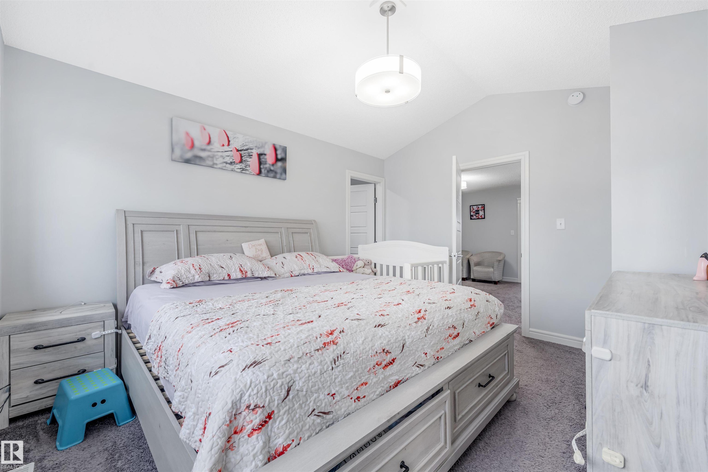 Light gray bedroom featuring a vaulted ceiling, recessed lighting, and gray carpeting - 1024 Daniels Loop, Edmonton, AB - Indoor Photo Showing Bedroom