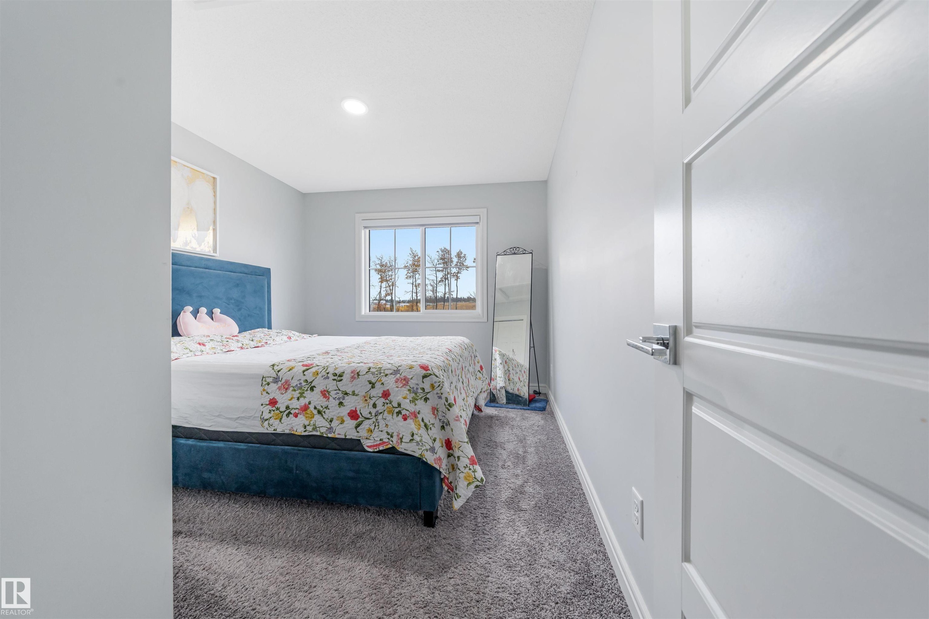 Bedroom featuring a window with exterior scenery, recessed lighting, light gray walls, and gray carpet flooring - 1024 Daniels Loop, Edmonton, AB - Indoor Photo Showing Bedroom