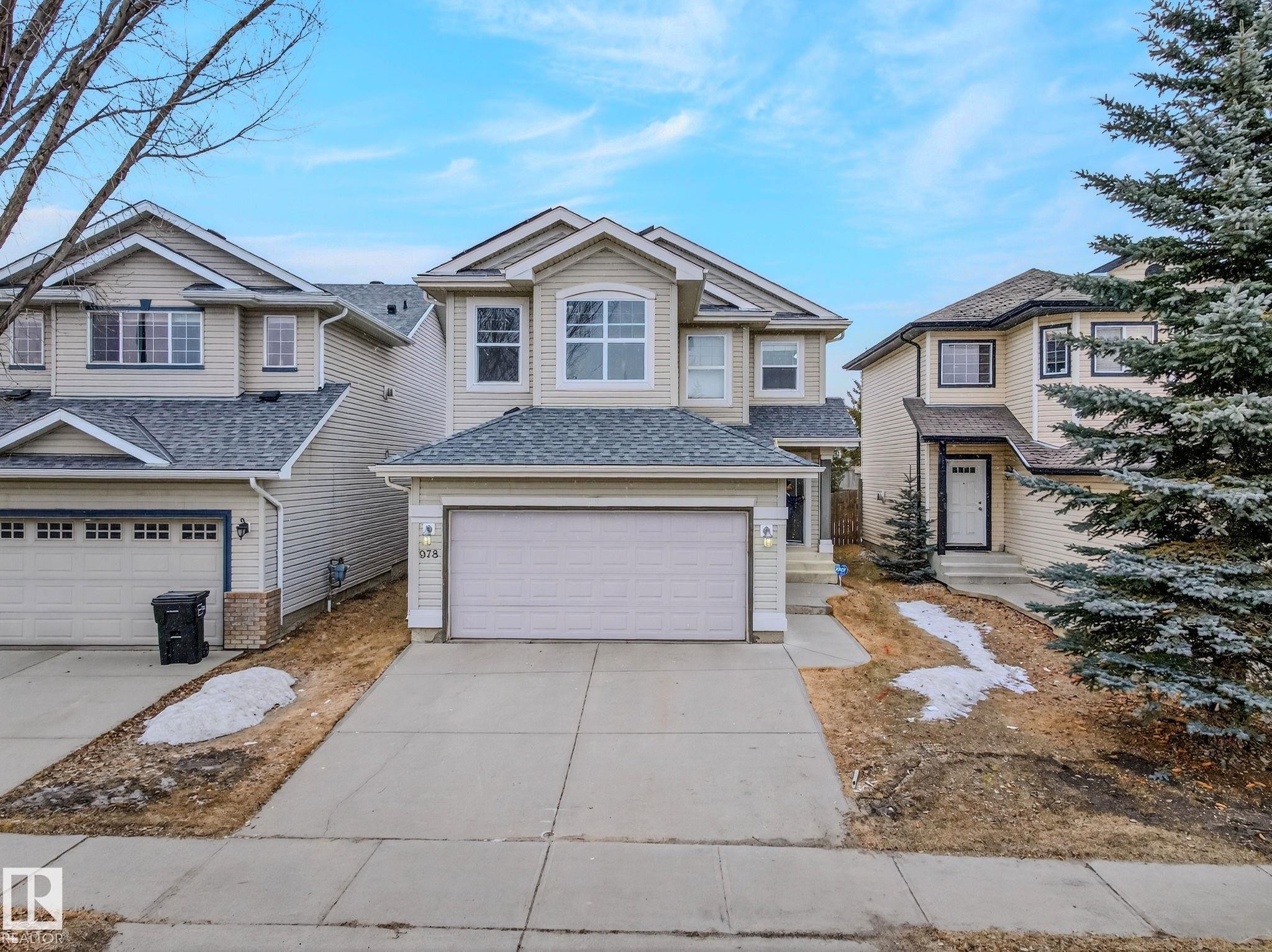 Two-story residential dwelling featuring light-colored siding and a gabled roof - 978 Rutherford Road Sw, Edmonton, AB - Outdoor With Facade