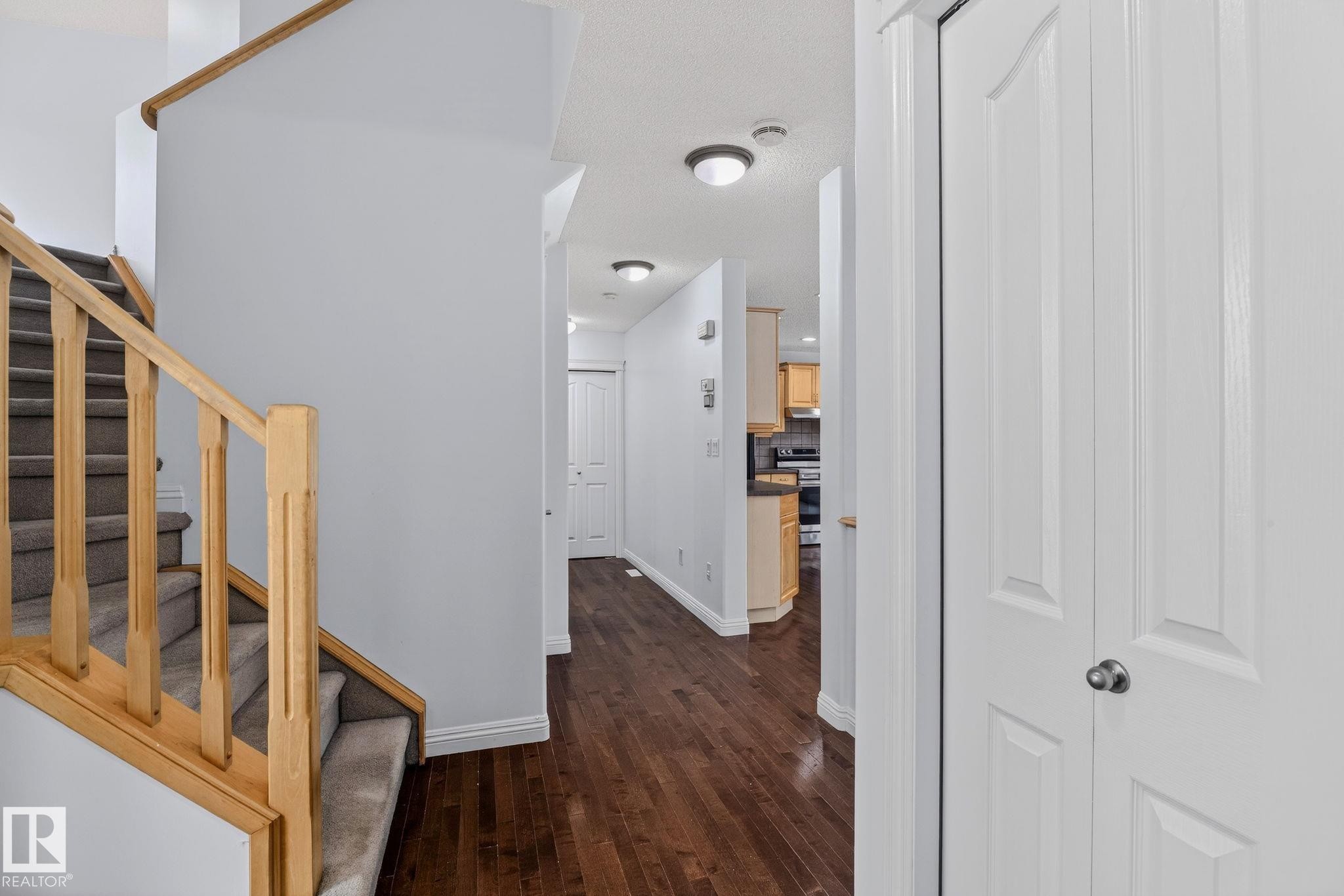 Wood-finish flooring throughout the hallway - 978 Rutherford Road Sw, Edmonton, AB - Indoor Photo Showing Other Room