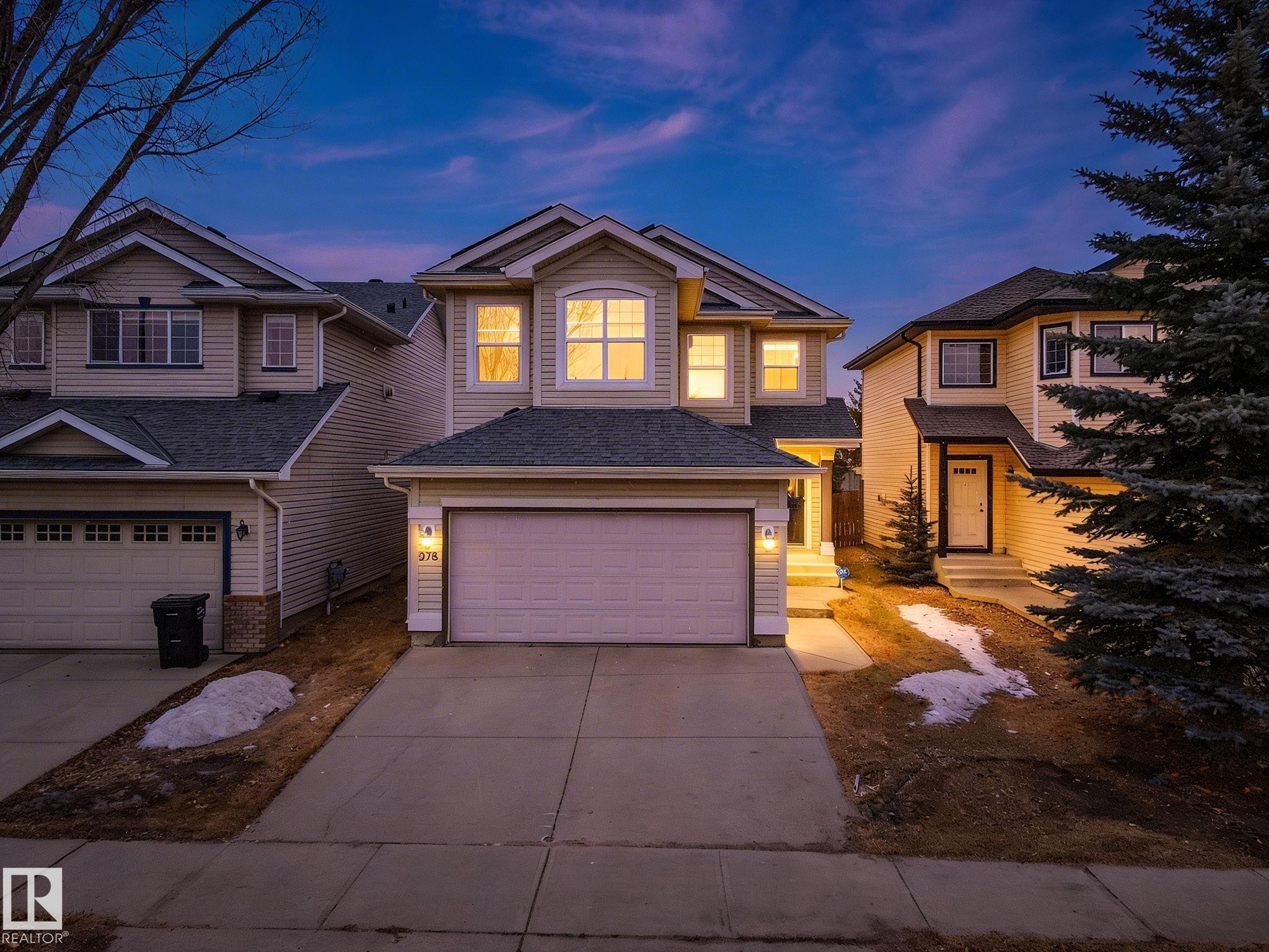 Two-story residence featuring light-toned horizontal siding and a dark shingle roof - 978 Rutherford Road Sw, Edmonton, AB - Outdoor With Facade