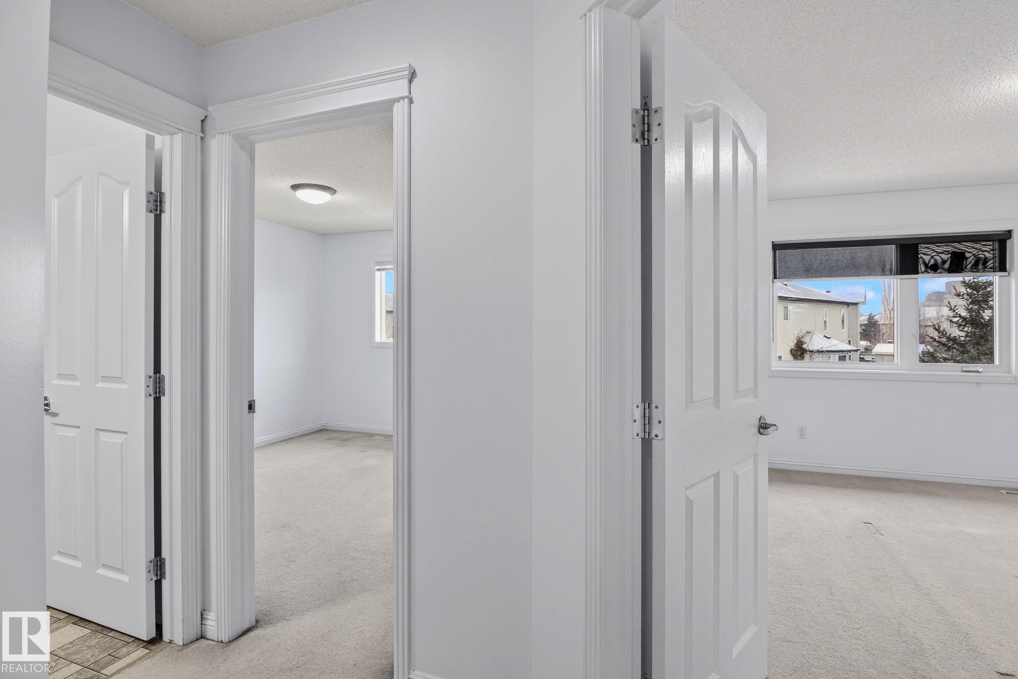 Interior hallway with multiple doorways offering access to individual rooms - 978 Rutherford Road Sw, Edmonton, AB - Indoor Photo Showing Other Room