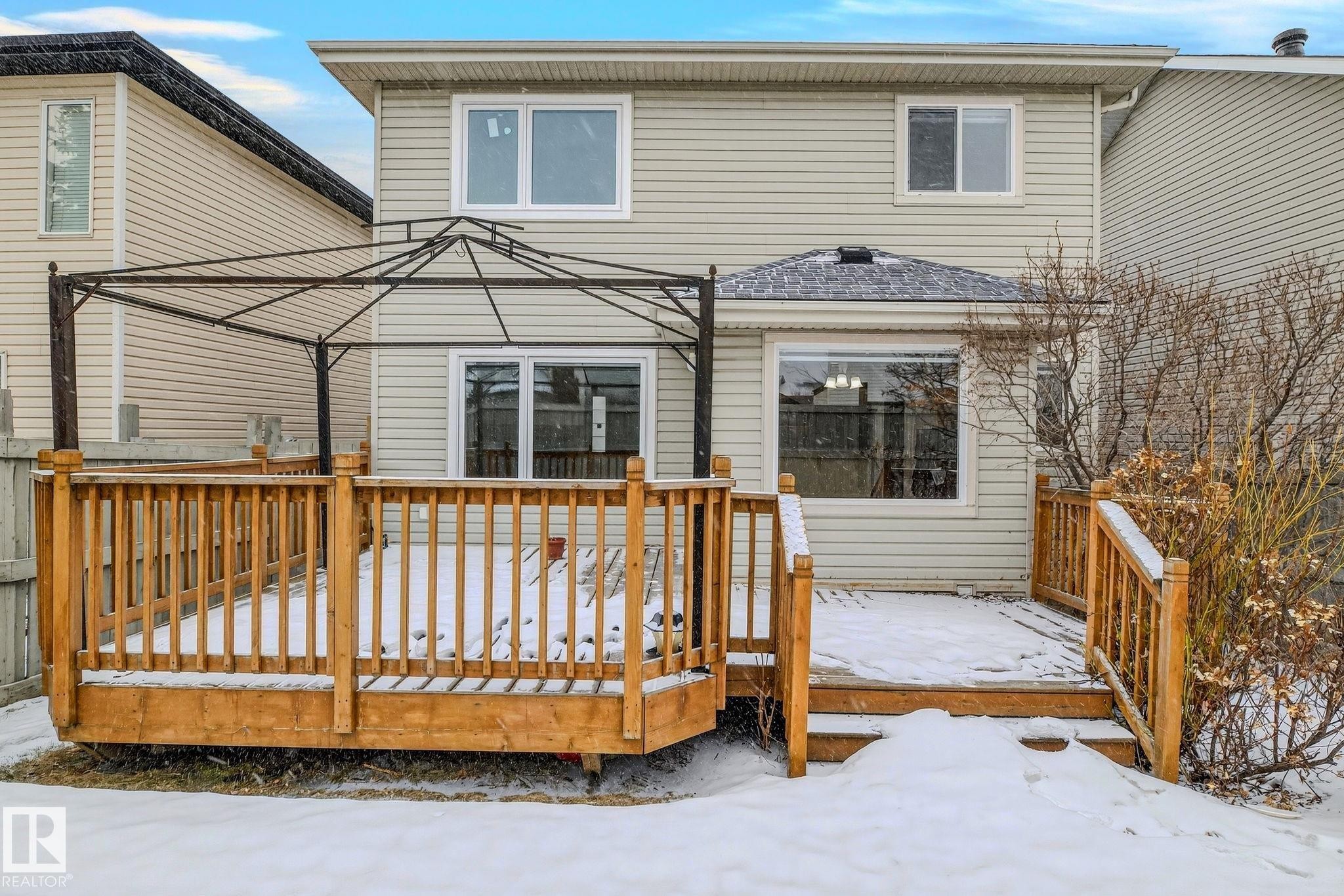 Exterior featuring light-colored siding and multiple windows - 978 Rutherford Road Sw, Edmonton, AB - Outdoor With Exterior