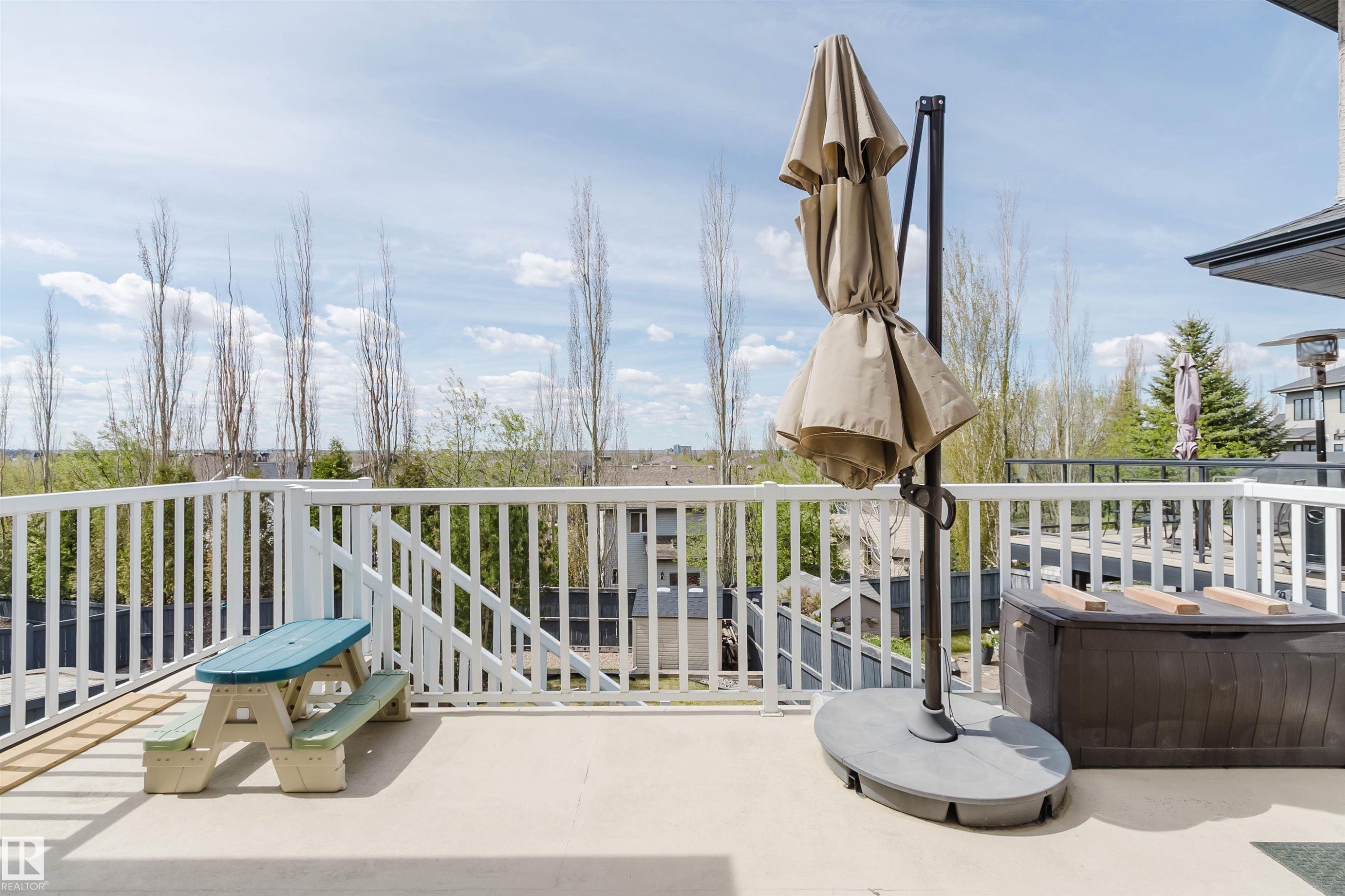 Spacious outdoor deck featuring a white spindle railing and a durable surface - 3412 Macneil Link, Edmonton, AB - Outdoor