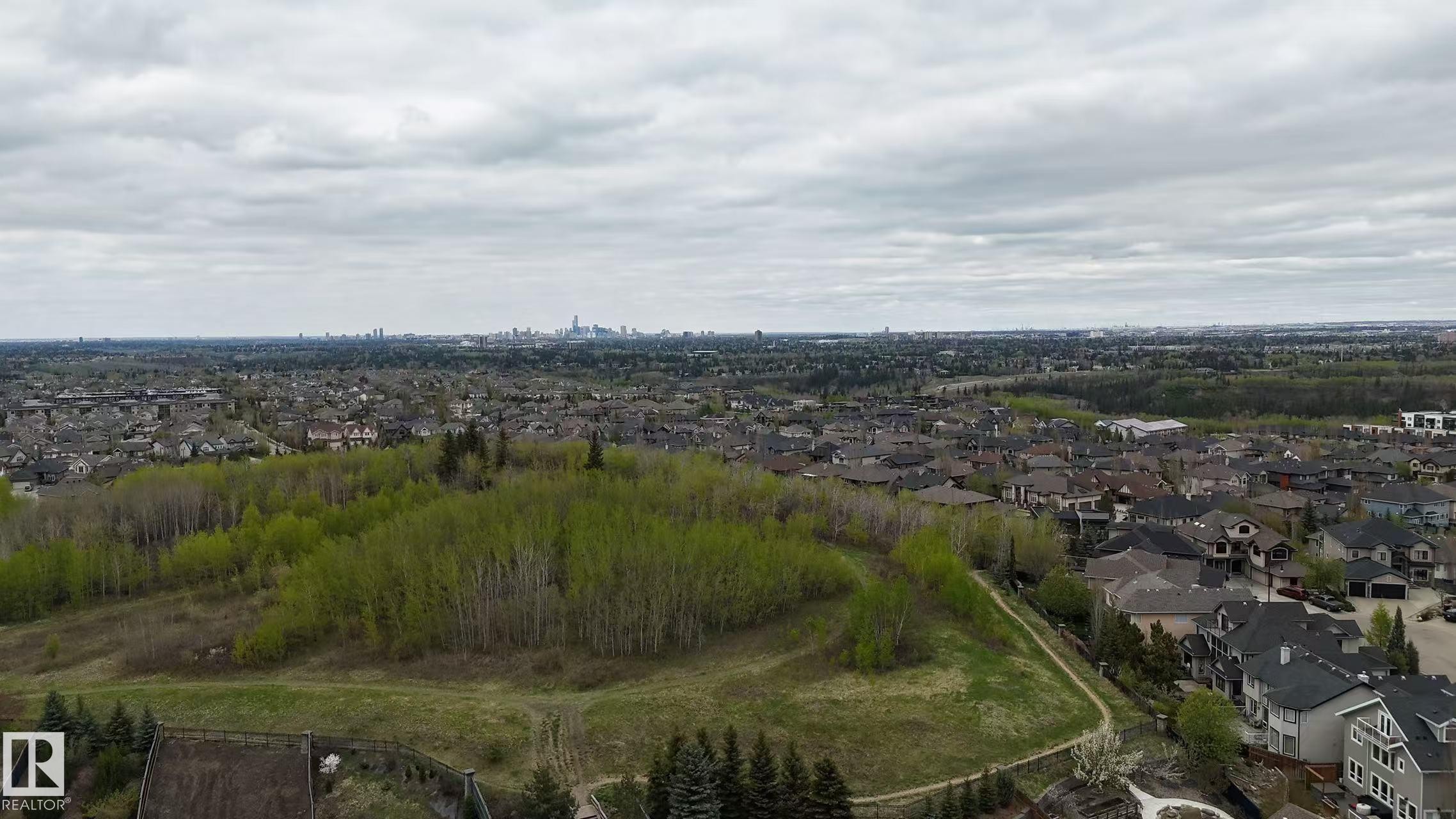 Expansive aerial perspective showcasing a residential area with a distant city skyline - 3412 Macneil Link, Edmonton, AB - Outdoor With View