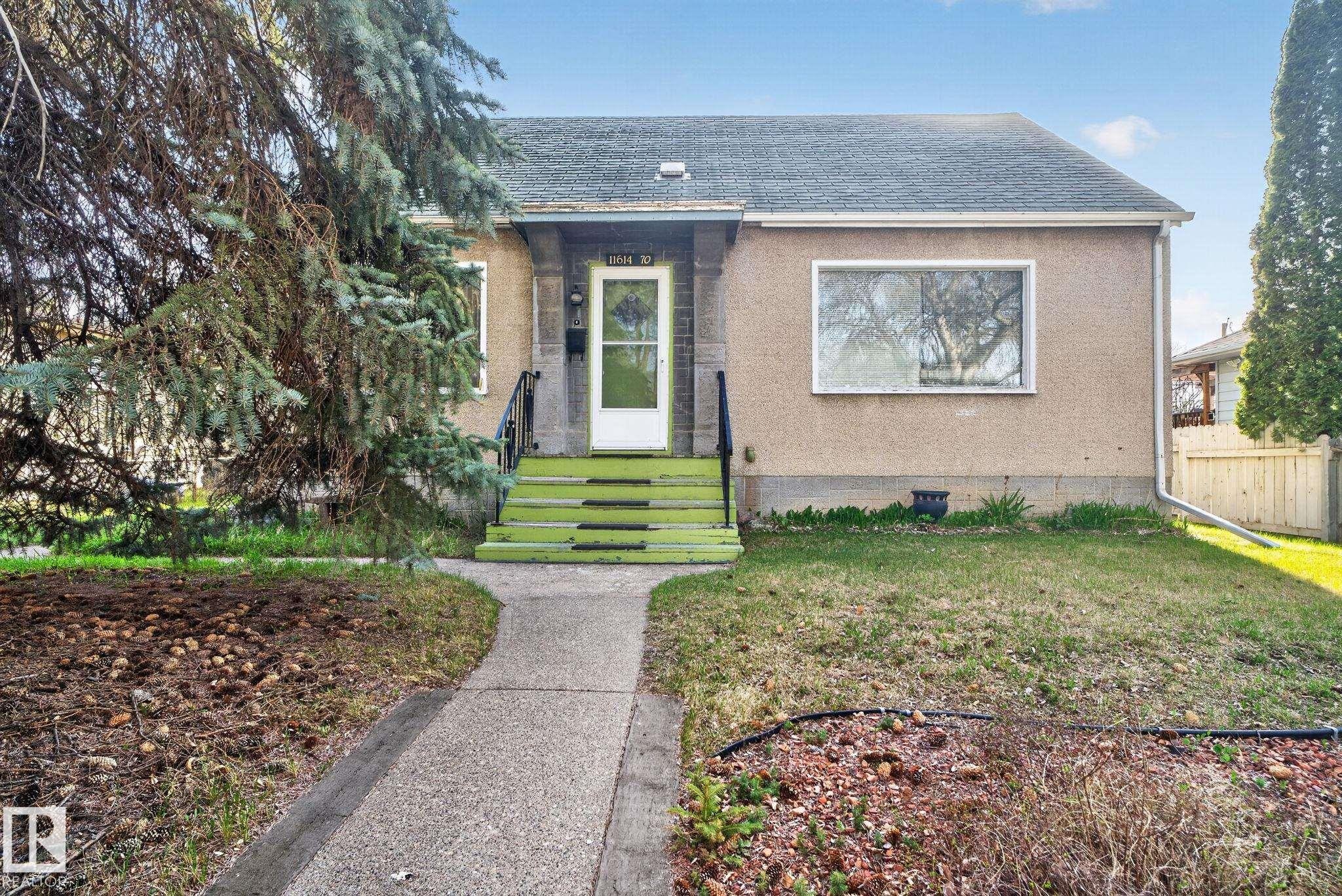 Single-story residence featuring a stucco exterior and gabled roofline - 11614 70 Street, Edmonton, AB