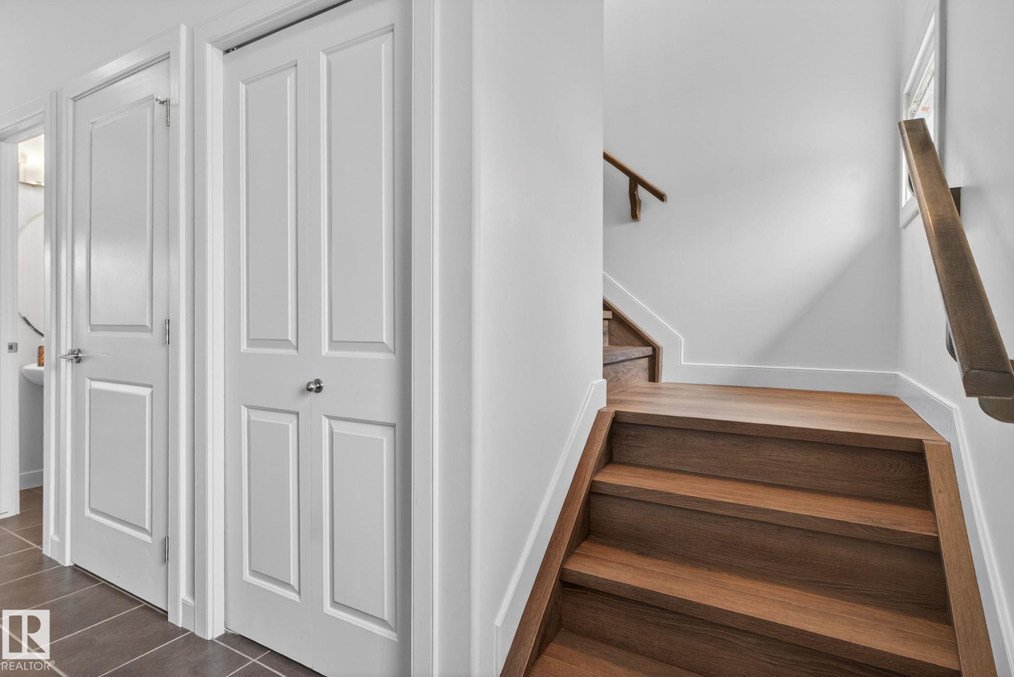 Hardwood stairs with coordinating wood handrail - 11 450 Mcconachie Way, Edmonton, AB - Indoor Photo Showing Other Room