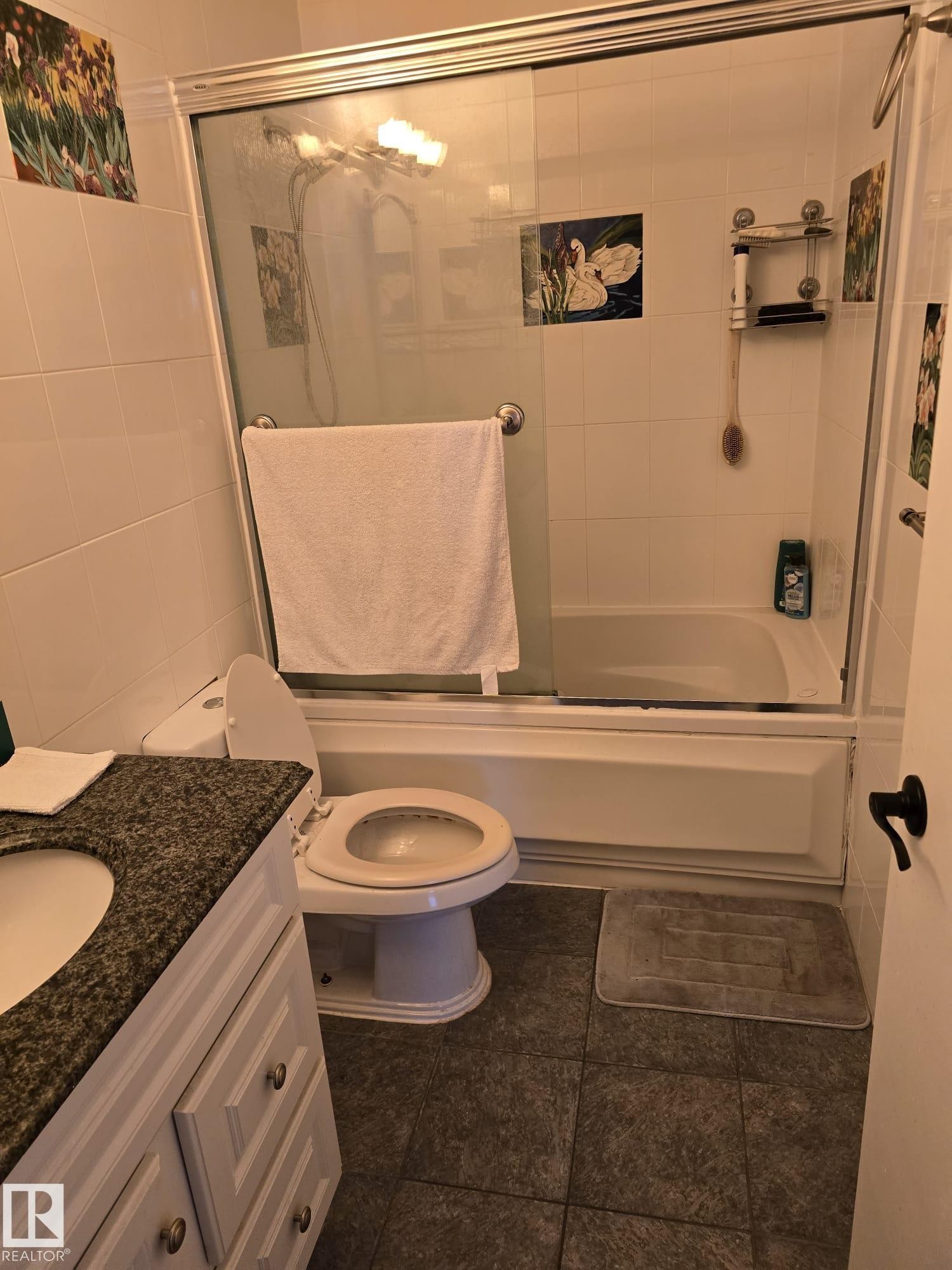 Bathroom featuring a granite-look vanity countertop, light-toned cabinetry, and dark tiled flooring - 11927 85 Street Nw, Edmonton, AB - Indoor Photo Showing Bathroom