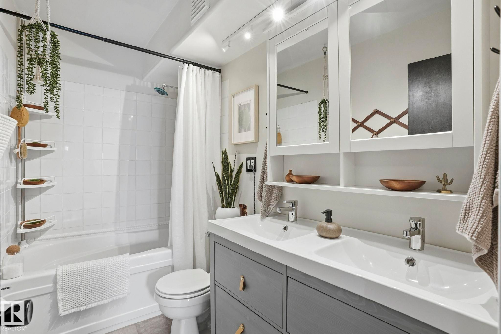 Bathroom featuring a dual vanity with undermount sinks, gray cabinetry, and white countertops - 4 Langley Dr, Fort Saskatchewan, AB - Indoor Photo Showing Bathroom
