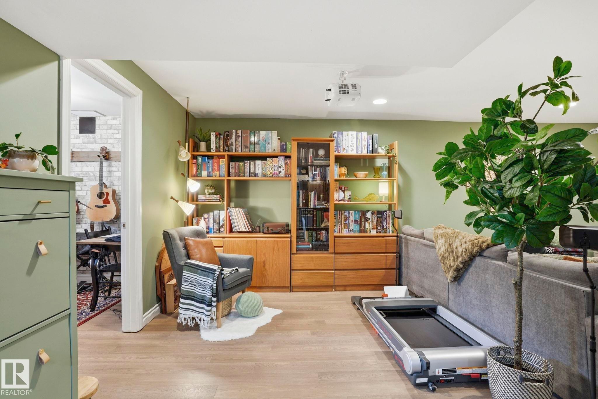 Recessed lighting illuminates wood-finish flooring and a built-in shelving unit - 4 Langley Dr, Fort Saskatchewan, AB - Indoor