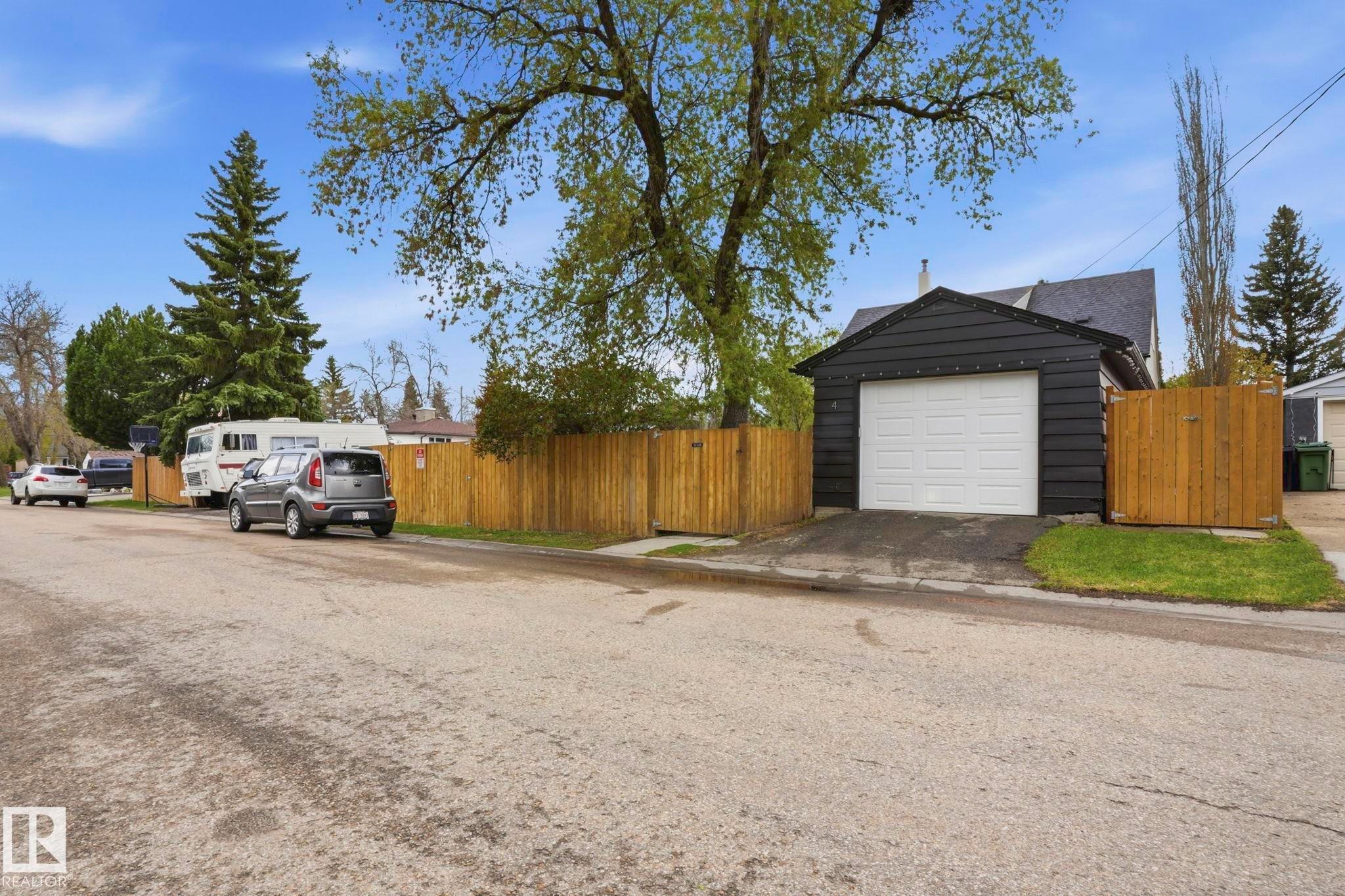 Detached garage featuring black siding and a white panel door - 4 Langley Dr, Fort Saskatchewan, AB - Outdoor