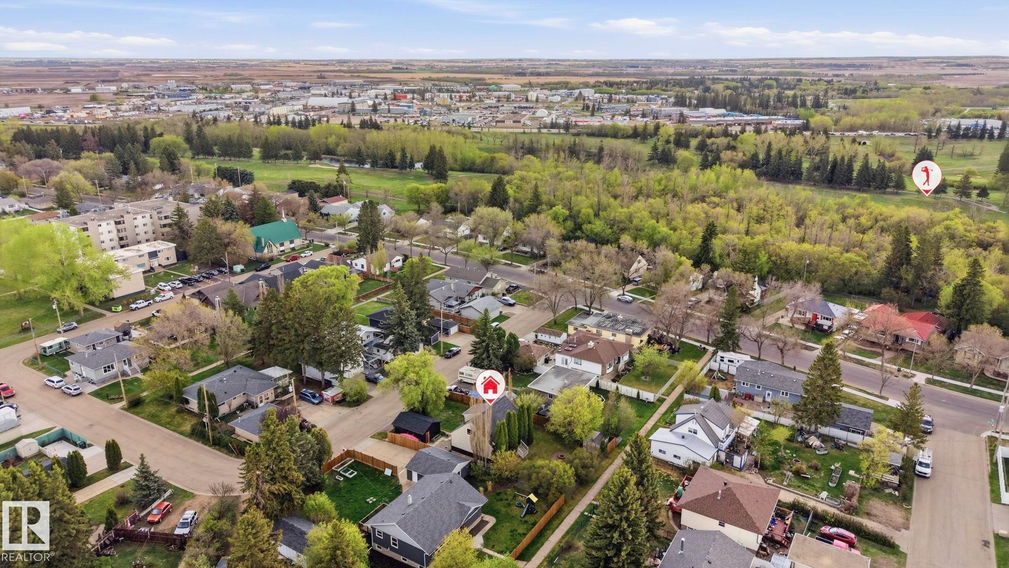 Aerial perspective of a residential neighborhood featuring established homes and mature trees - 4 Langley Dr, Fort Saskatchewan, AB - Outdoor With View