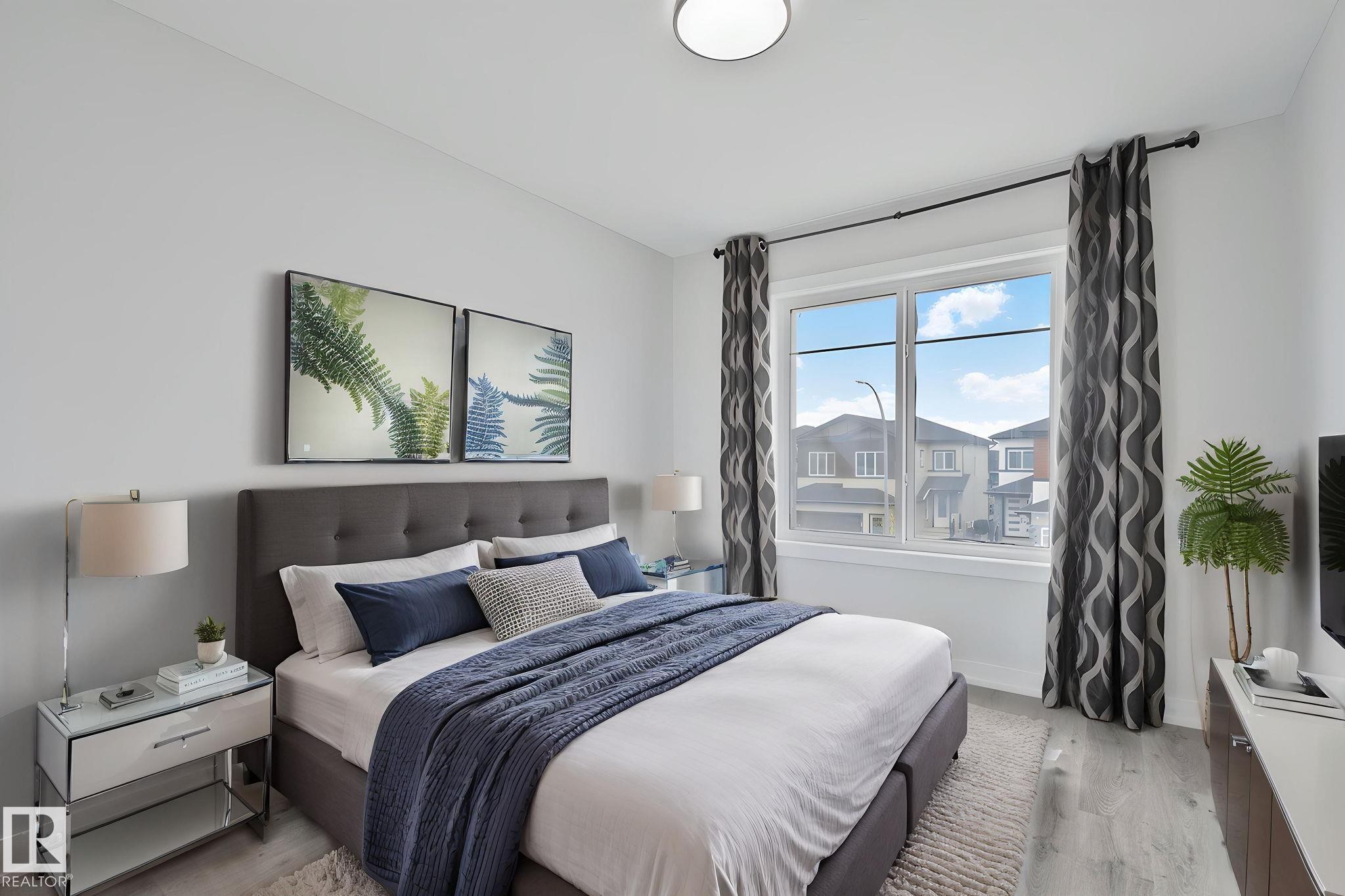 Window with double-pane glass, light grey walls, and wood-finish flooring - 334 Aston Close, Leduc, AB - Indoor Photo Showing Bedroom
