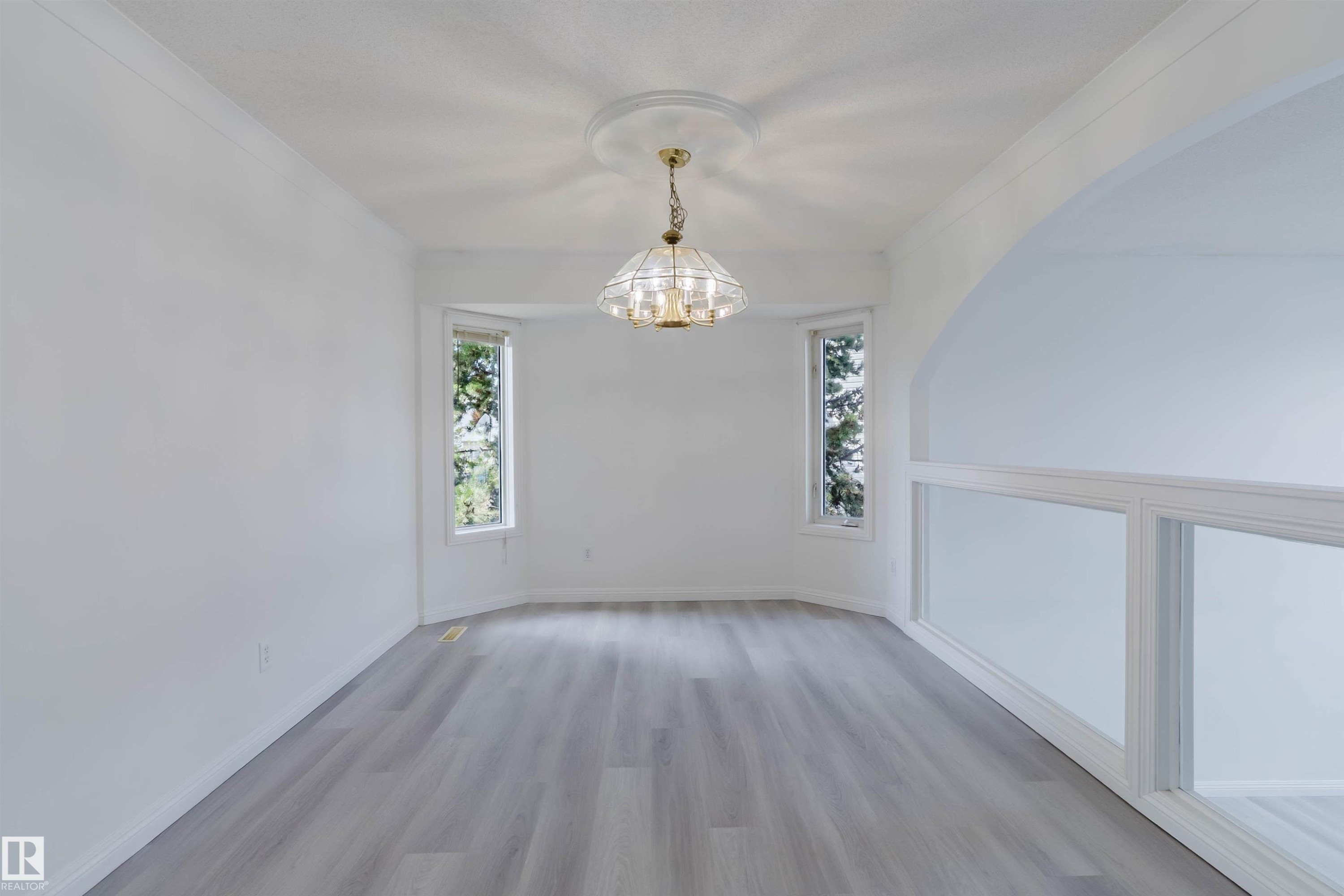 Room featuring wood-finish flooring, white walls, and crown molding - 13755 131B Avenue, Edmonton, AB - Indoor Photo Showing Other Room