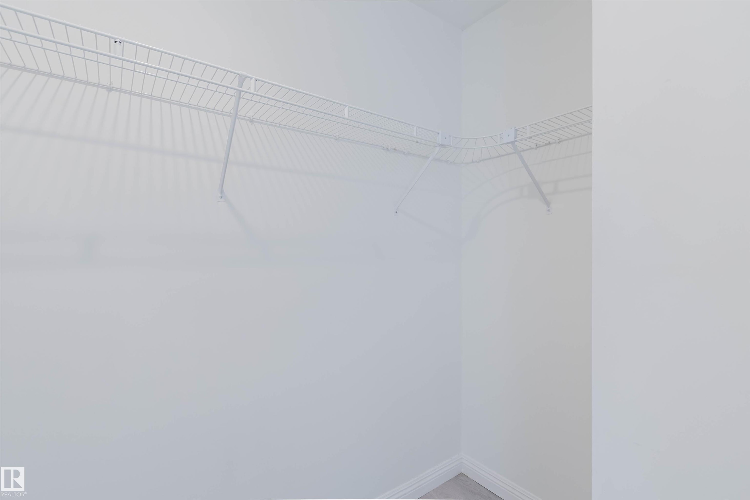 White wire shelving installed in an alcove with light-colored walls and baseboards - 13755 131B Avenue, Edmonton, AB - Indoor With Storage