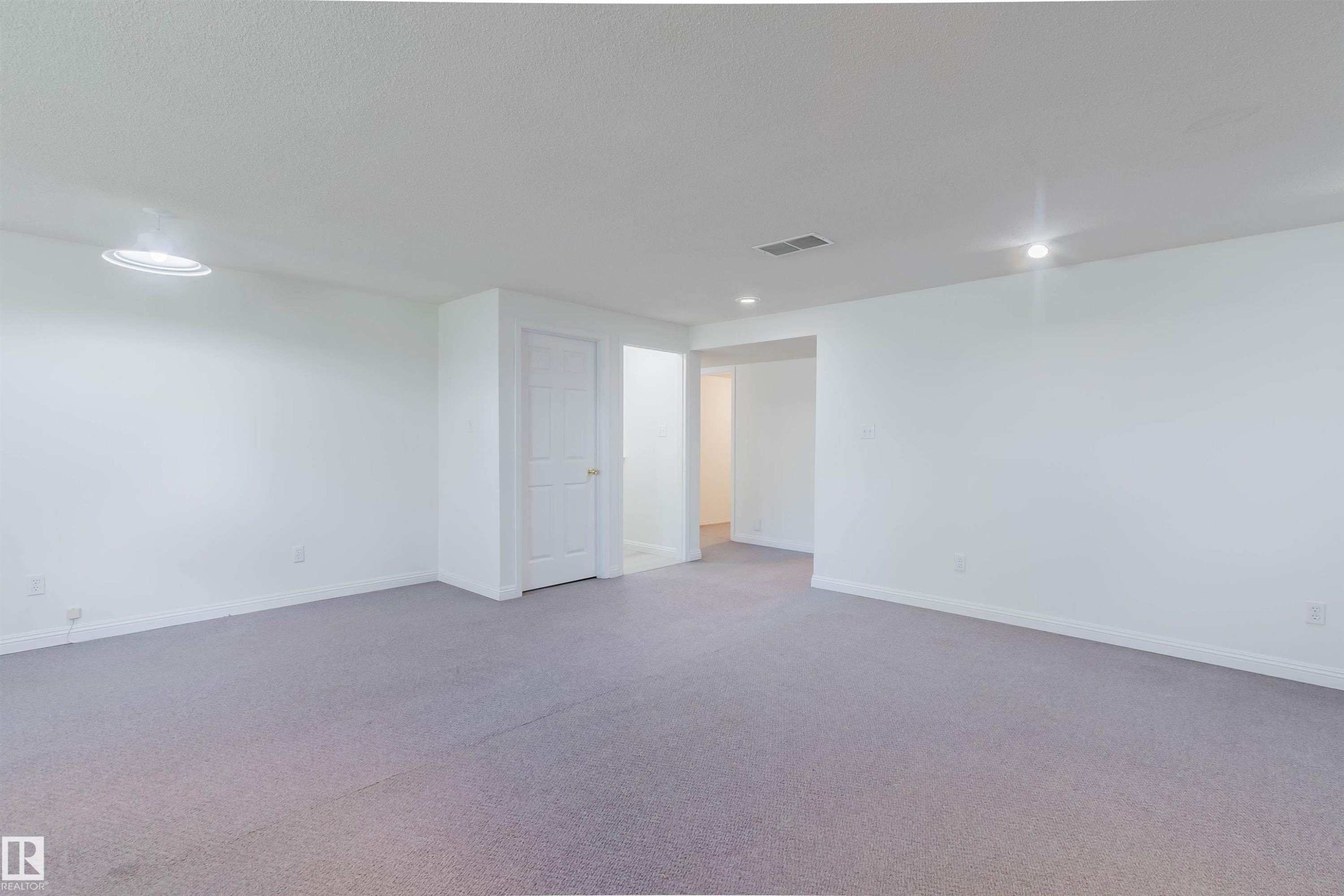 Spacious room featuring light gray carpeting, white walls, and recessed lighting - 13755 131B Avenue, Edmonton, AB - Indoor Photo Showing Other Room