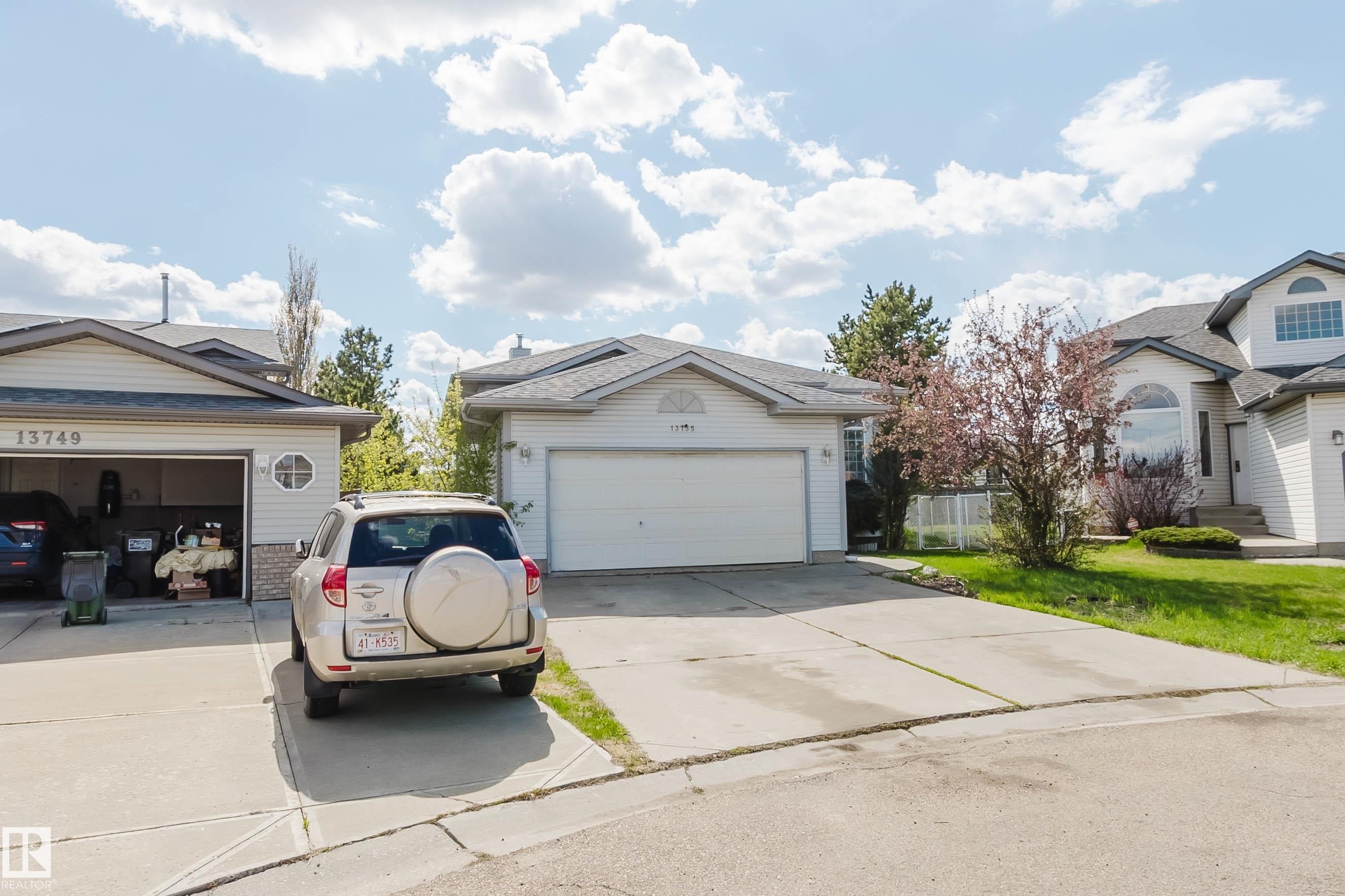 Single-family residence featuring a two-car garage, concrete driveway, and light-colored siding - 13755 131B Avenue, Edmonton, AB - Outdoor With Facade