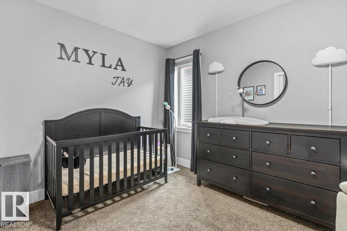 Carpeted room with light gray walls - 219 Cranberry Bend, Fort Saskatchewan, AB - Indoor Photo Showing Bedroom