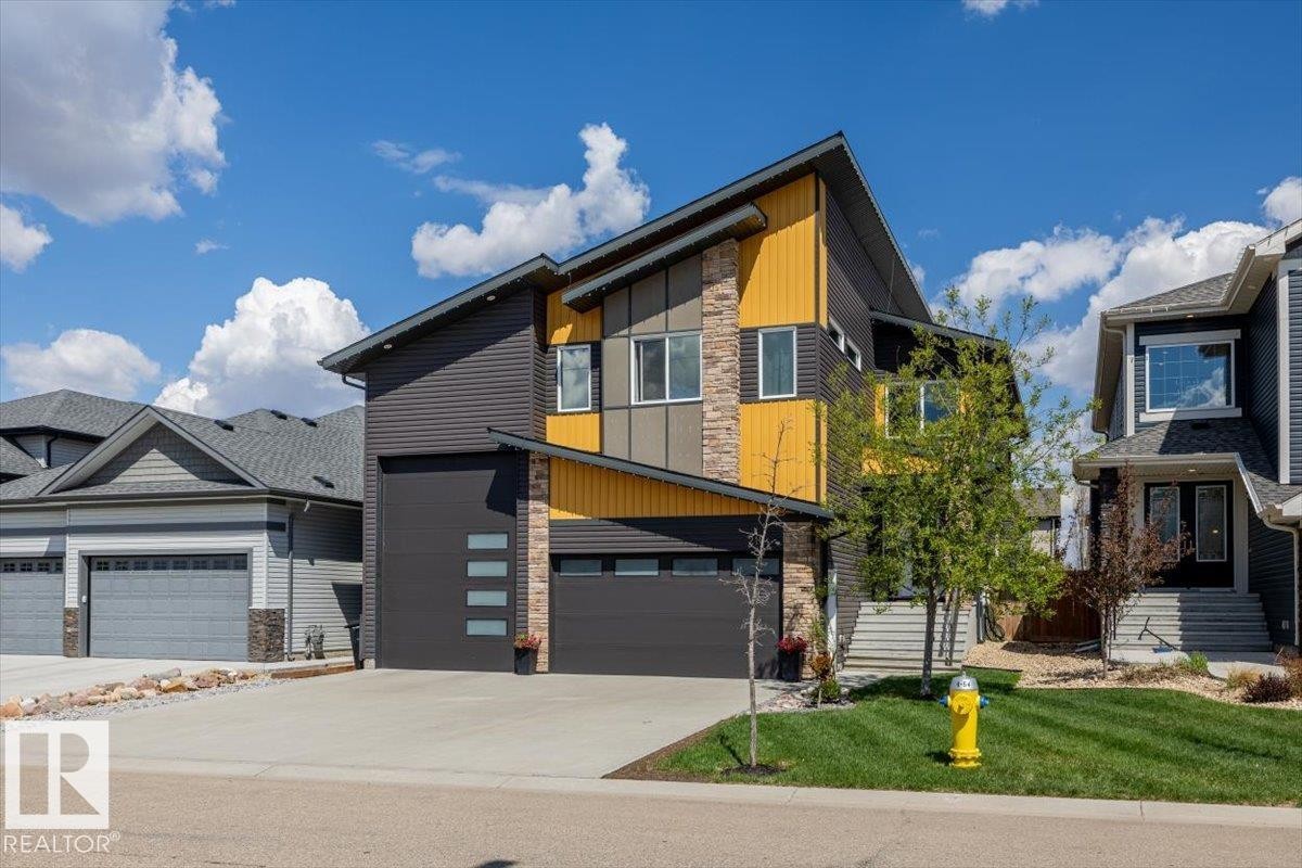 Contemporary architecture featuring multiple exterior finishes, an attached two-car garage, and a concrete driveway - 219 Cranberry Bend, Fort Saskatchewan, AB - Outdoor With Facade
