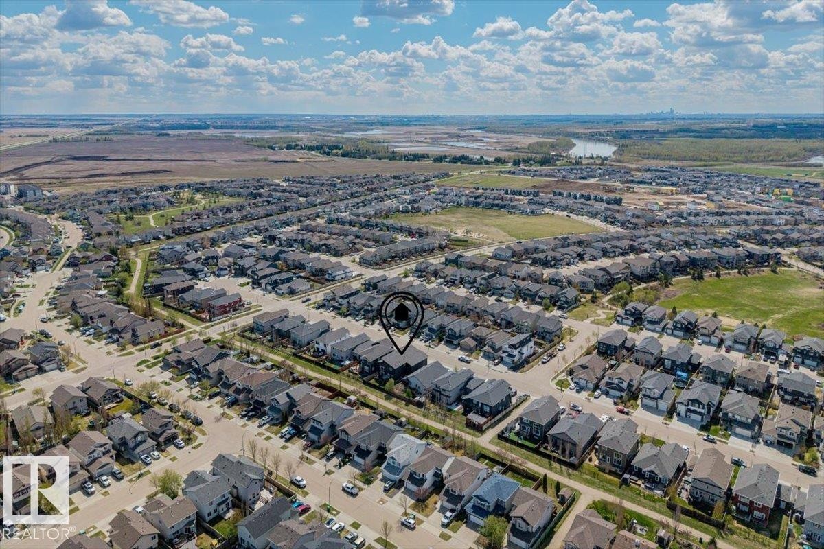 Aerial perspective showcasing a residential development with a mix of two-story and single-story homes - 219 Cranberry Bend, Fort Saskatchewan, AB - Outdoor With View