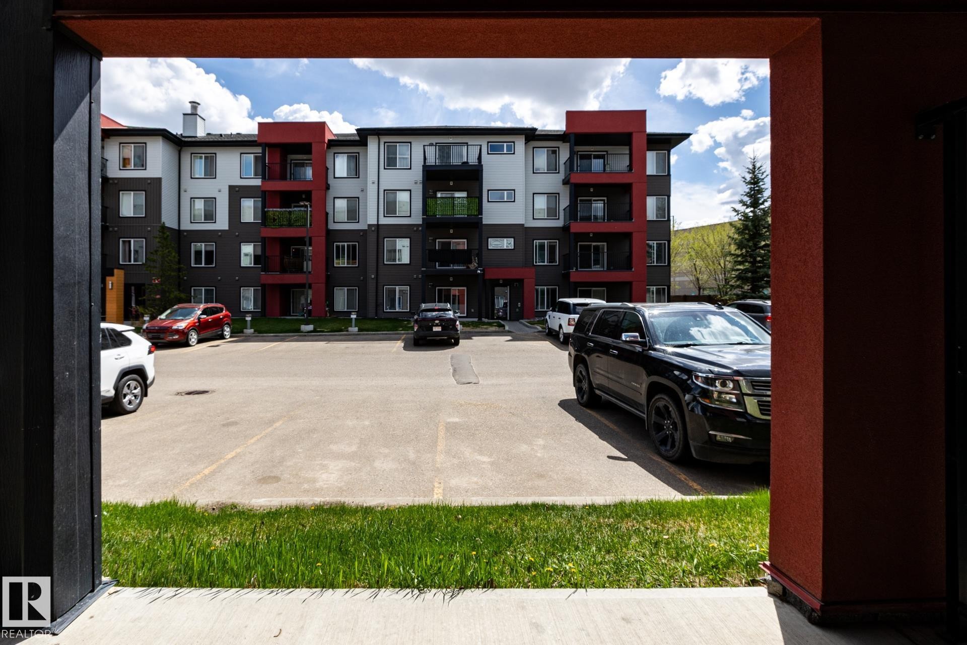 Contemporary multifamily building with multi-toned facade, private balconies, and a surface parking area - 131 344 Windermere Road, Edmonton, AB - Outdoor With Facade