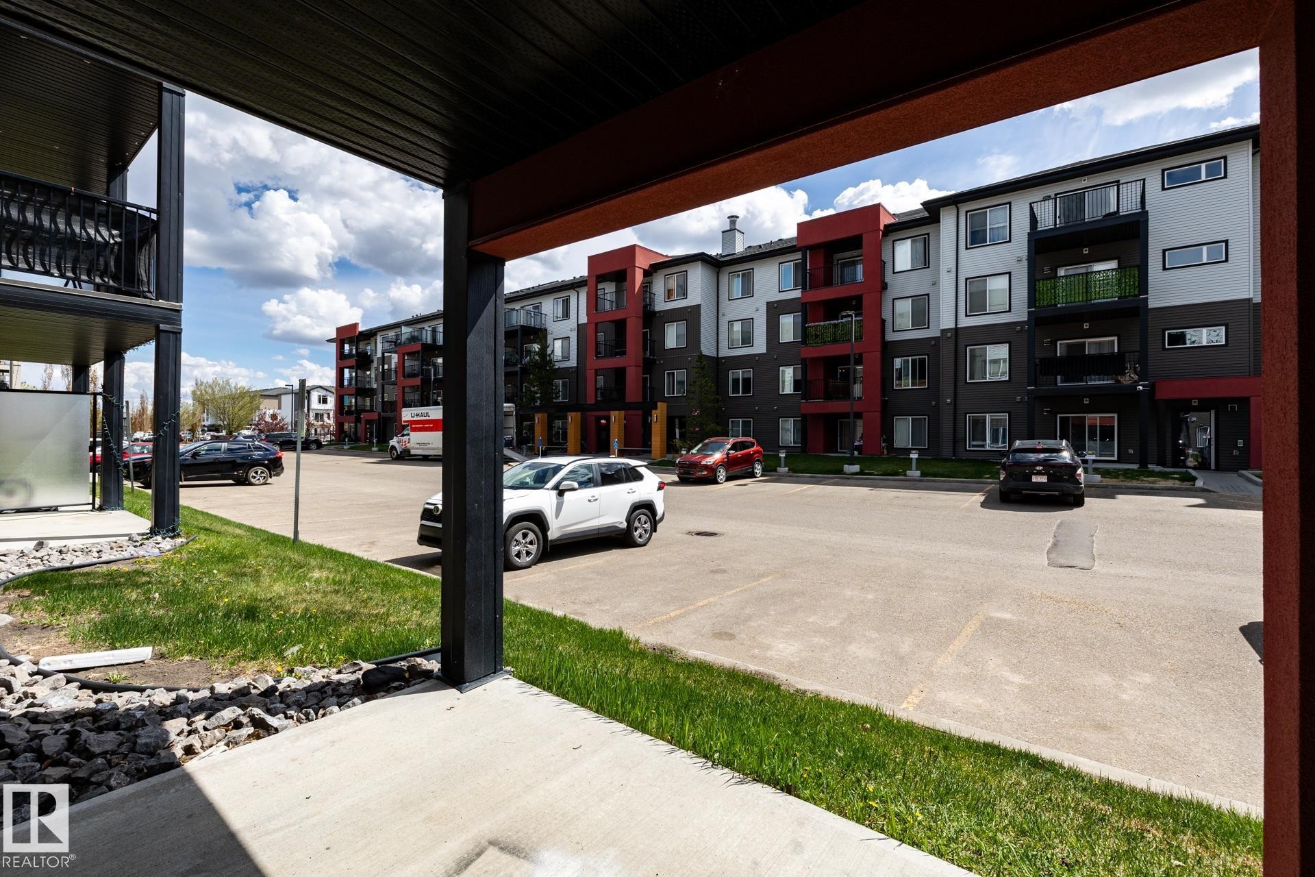 Multi-story residential building featuring a modern facade with red, gray, and black accents - 131 344 Windermere Road, Edmonton, AB - Outdoor