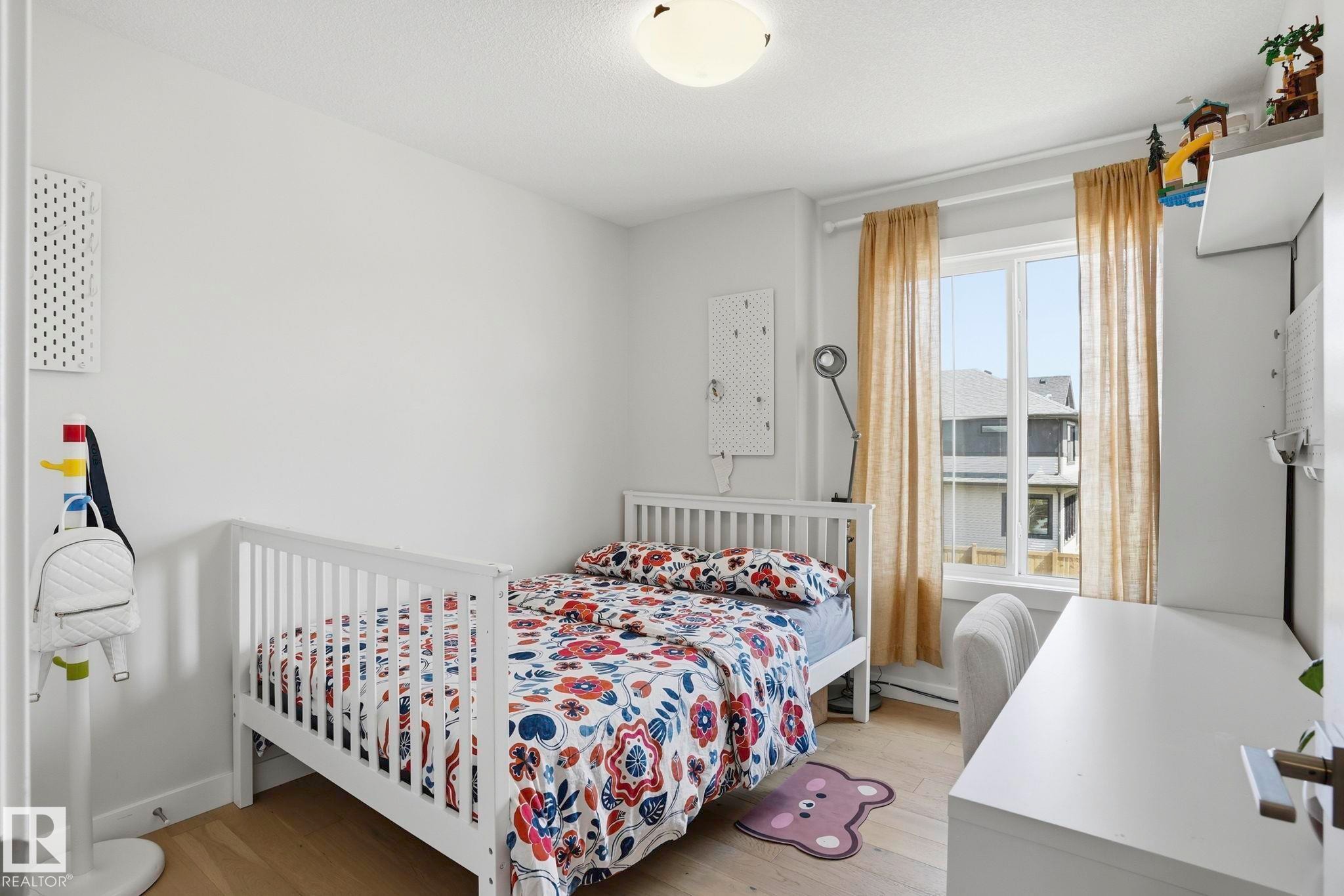 Bright room featuring light wood-finish flooring and white painted walls - 2116 159 Street, Edmonton, AB - Indoor Photo Showing Bedroom