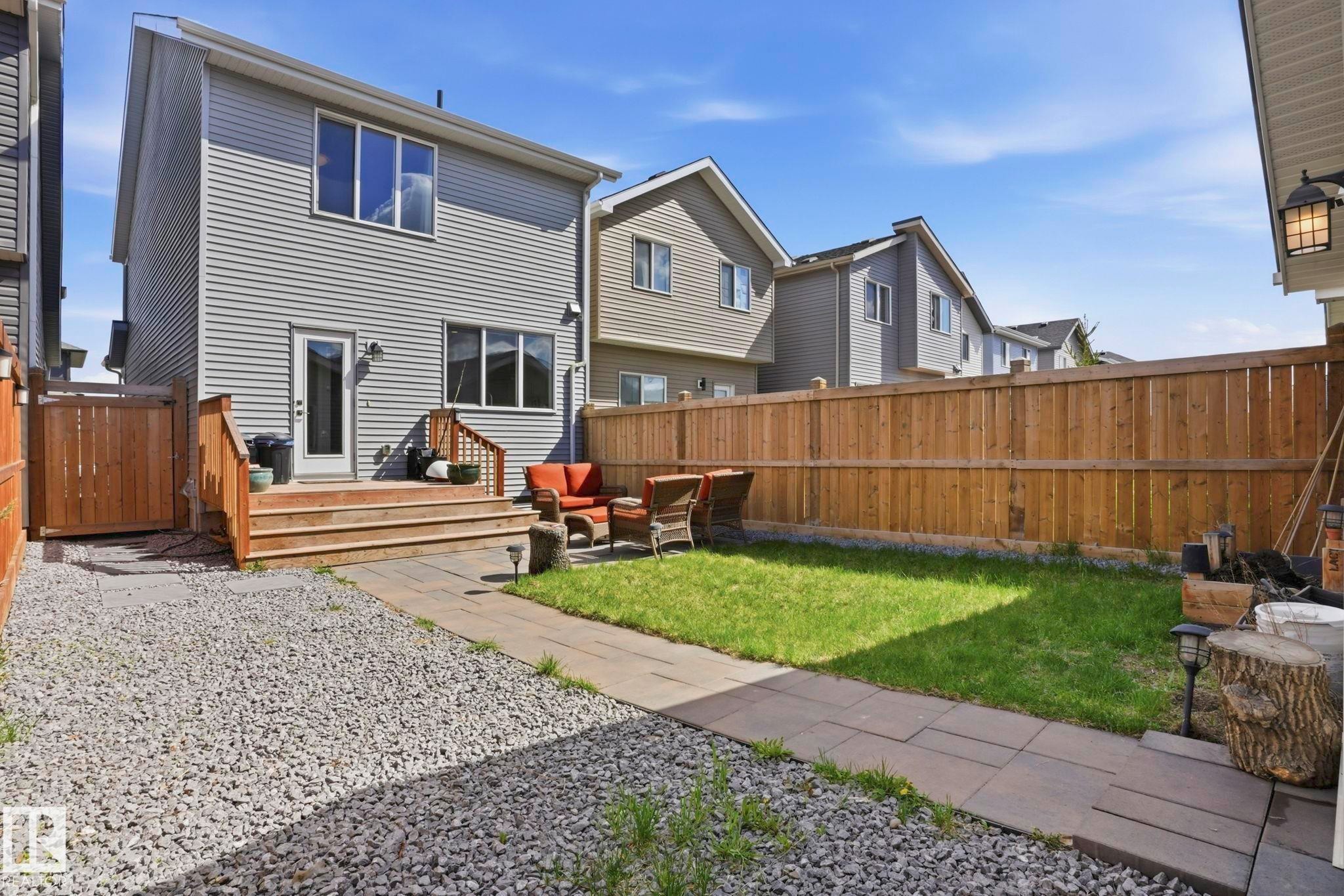 Rear exterior featuring grey horizontal siding and multiple windows - 2116 159 Street, Edmonton, AB - Outdoor