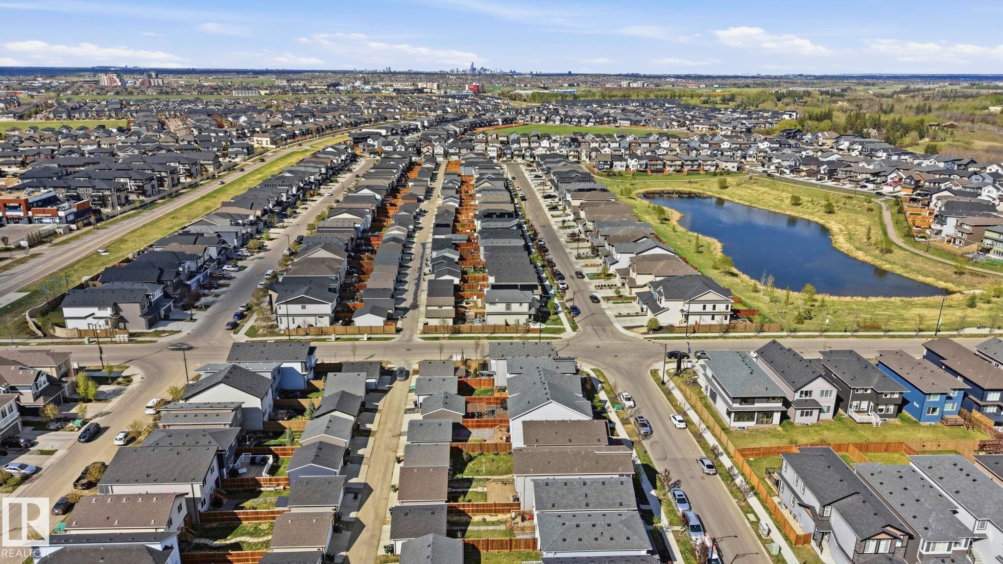 Developed residential neighborhood featuring single-family homes with varied exterior finishes and black shingle roofs - 2116 159 Street, Edmonton, AB - Outdoor With View