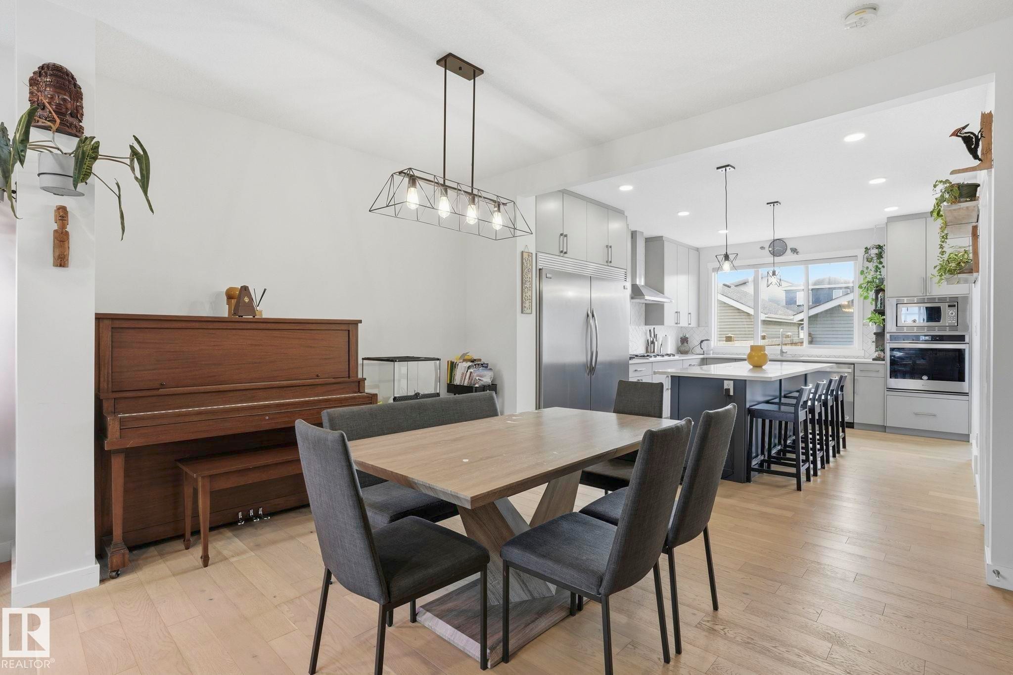 Open-concept kitchen and dining area featuring light wood-finish flooring - 2116 159 Street, Edmonton, AB - Indoor Photo Showing Dining Room