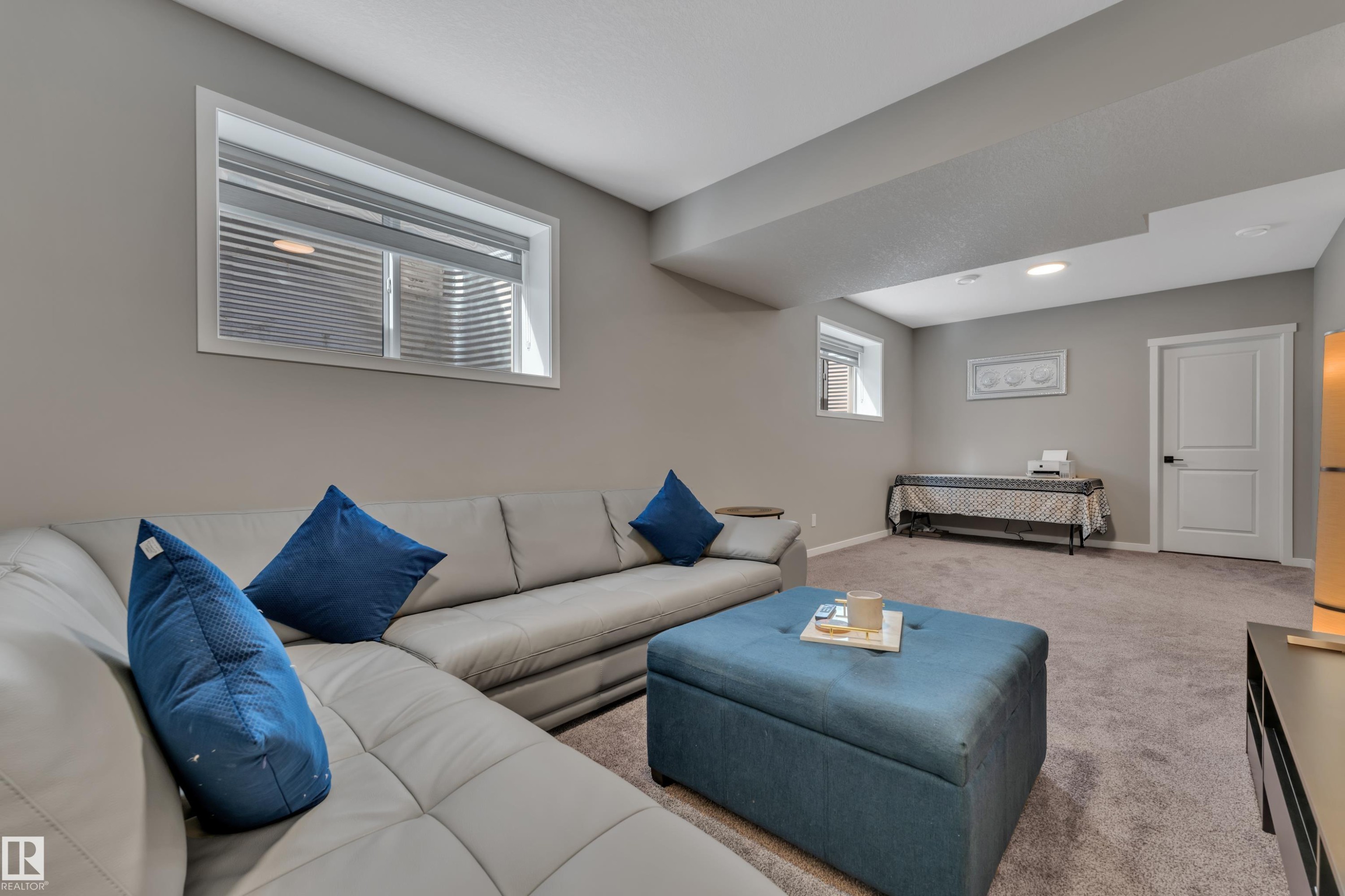 This versatile space features carpeting, recessed lighting, and a window with blinds - 21853 98A Avenue, Edmonton, AB - Indoor