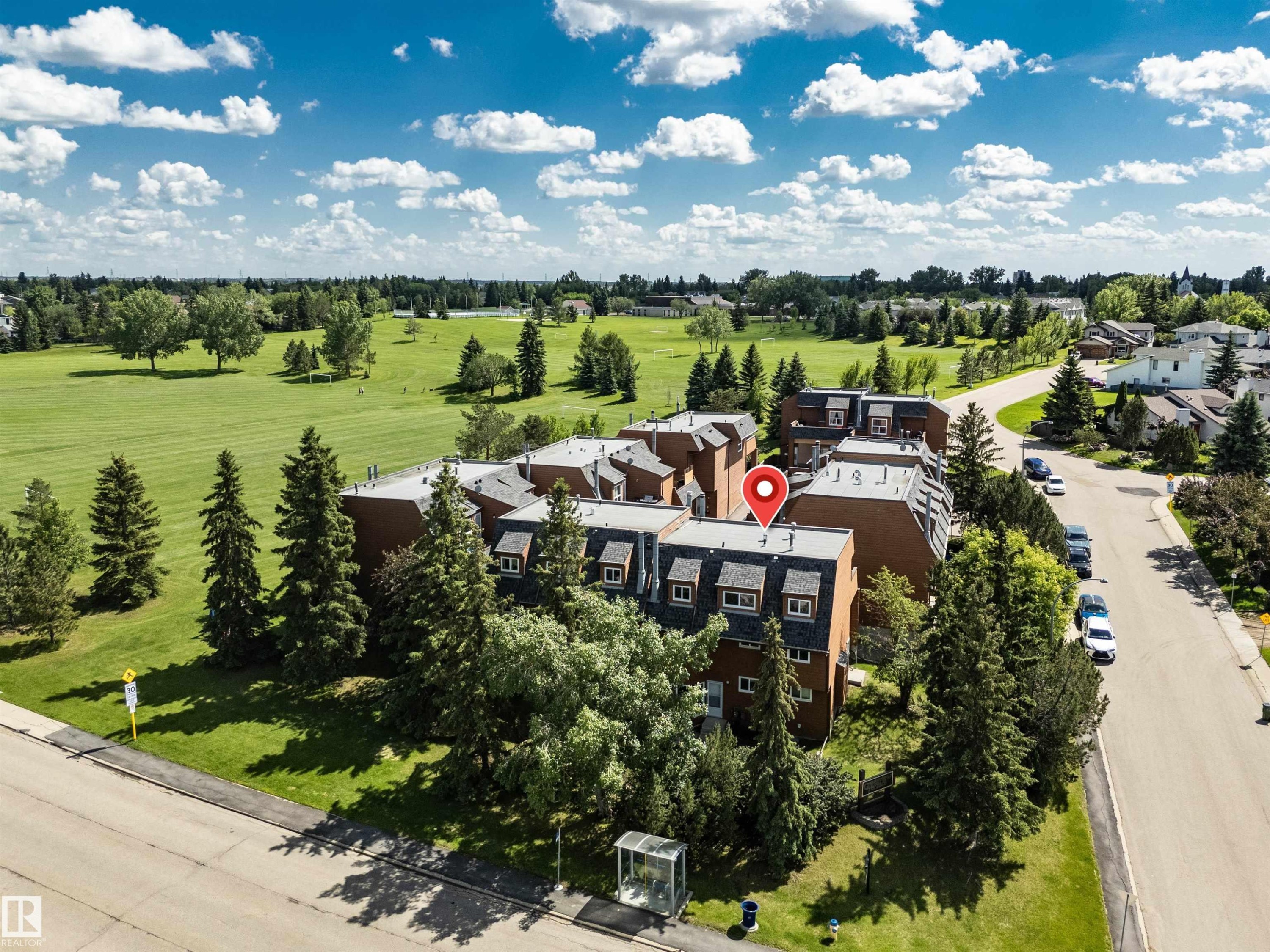 Multi-story building featuring dormer windows, a pitched roof, and brick exterior - 5953 40 Avenue, Edmonton, AB
