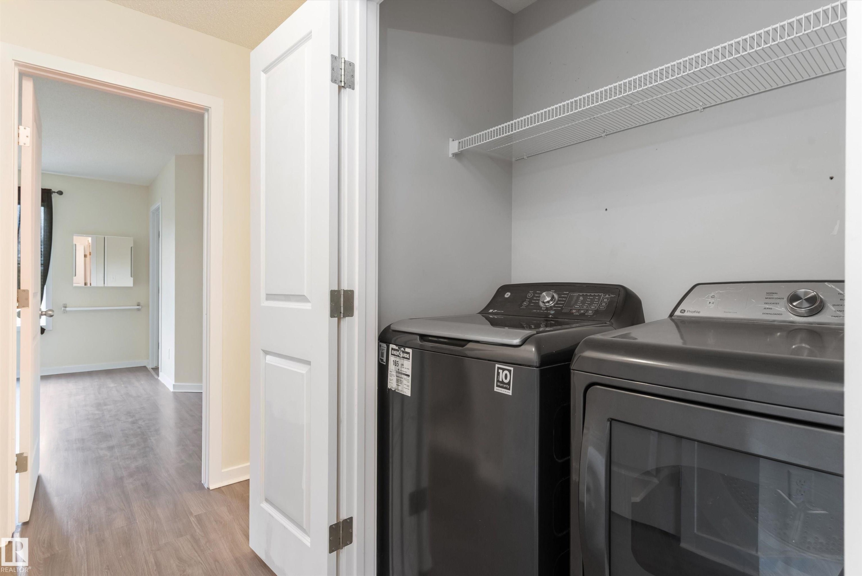 Dedicated laundry area featuring a wire storage shelf and gray appliances - 336 Watt Boulevard, Edmonton, AB - Indoor Photo Showing Laundry Room