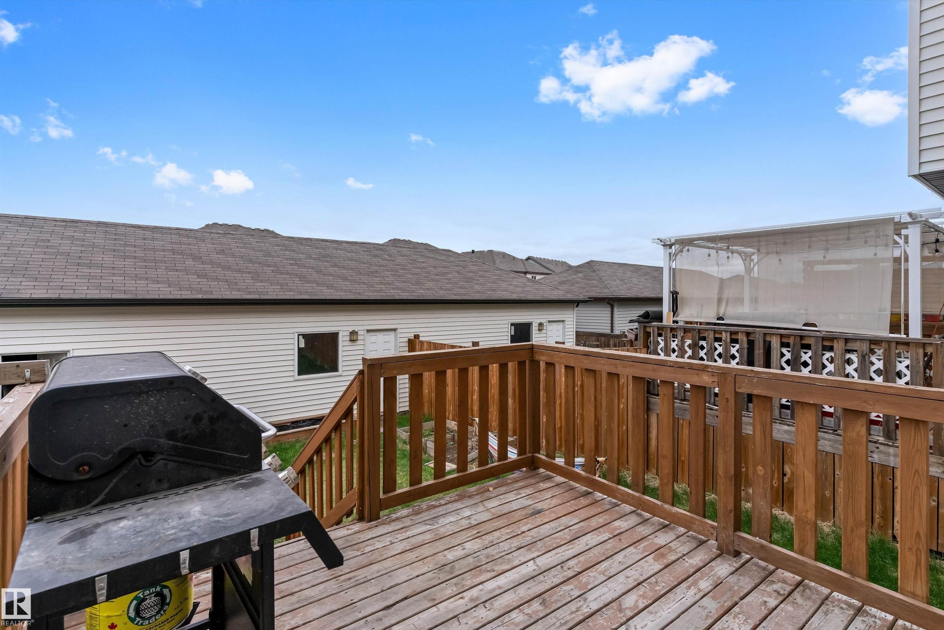 Expansive wood deck with a full-height wood railing and staircase - 336 Watt Boulevard, Edmonton, AB - Outdoor With Deck Patio Veranda With Exterior