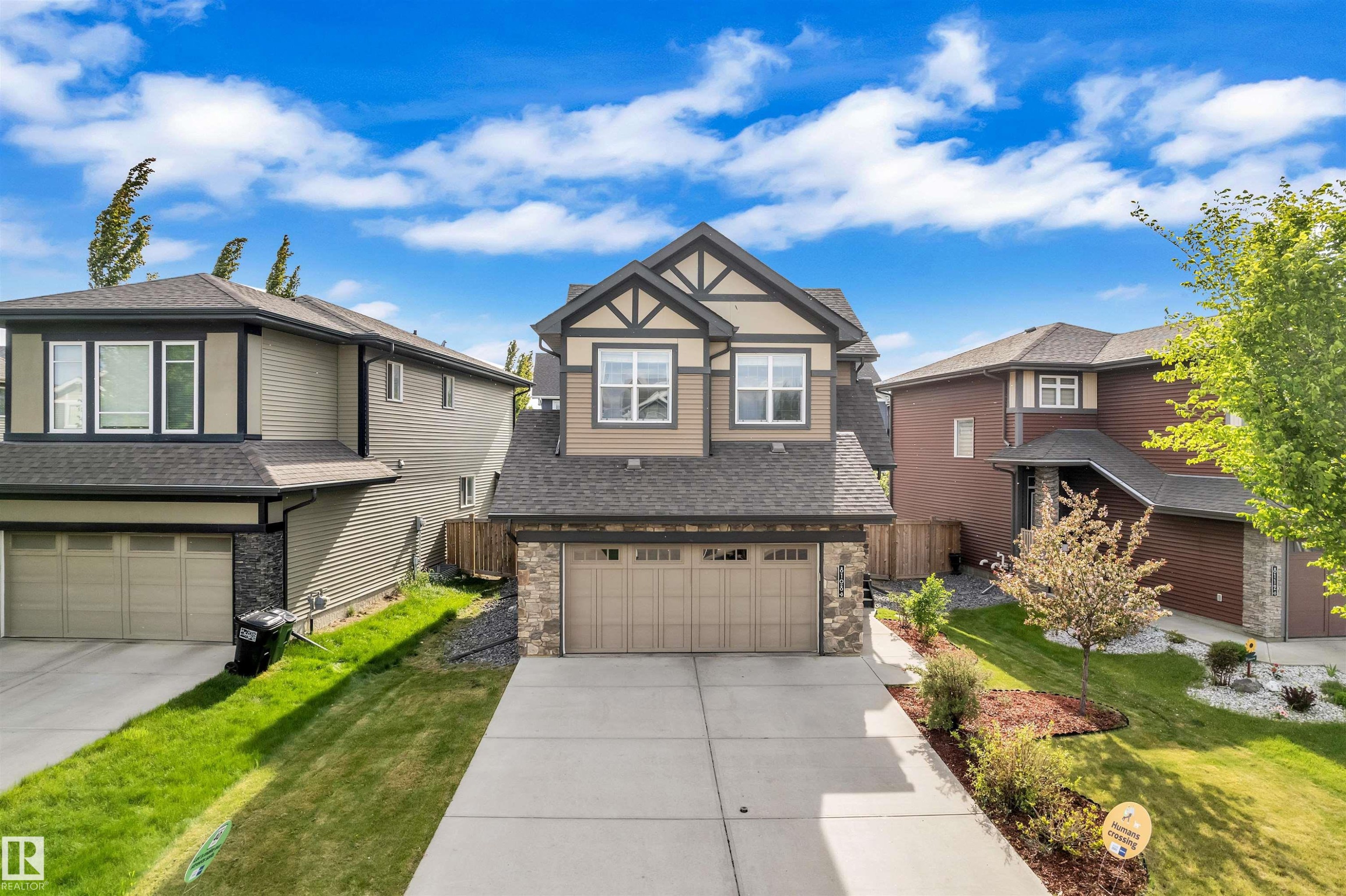 The property features a two-story home with a two-car garage and a paved driveway - 8108 217 Street, Edmonton, AB - Outdoor With Facade