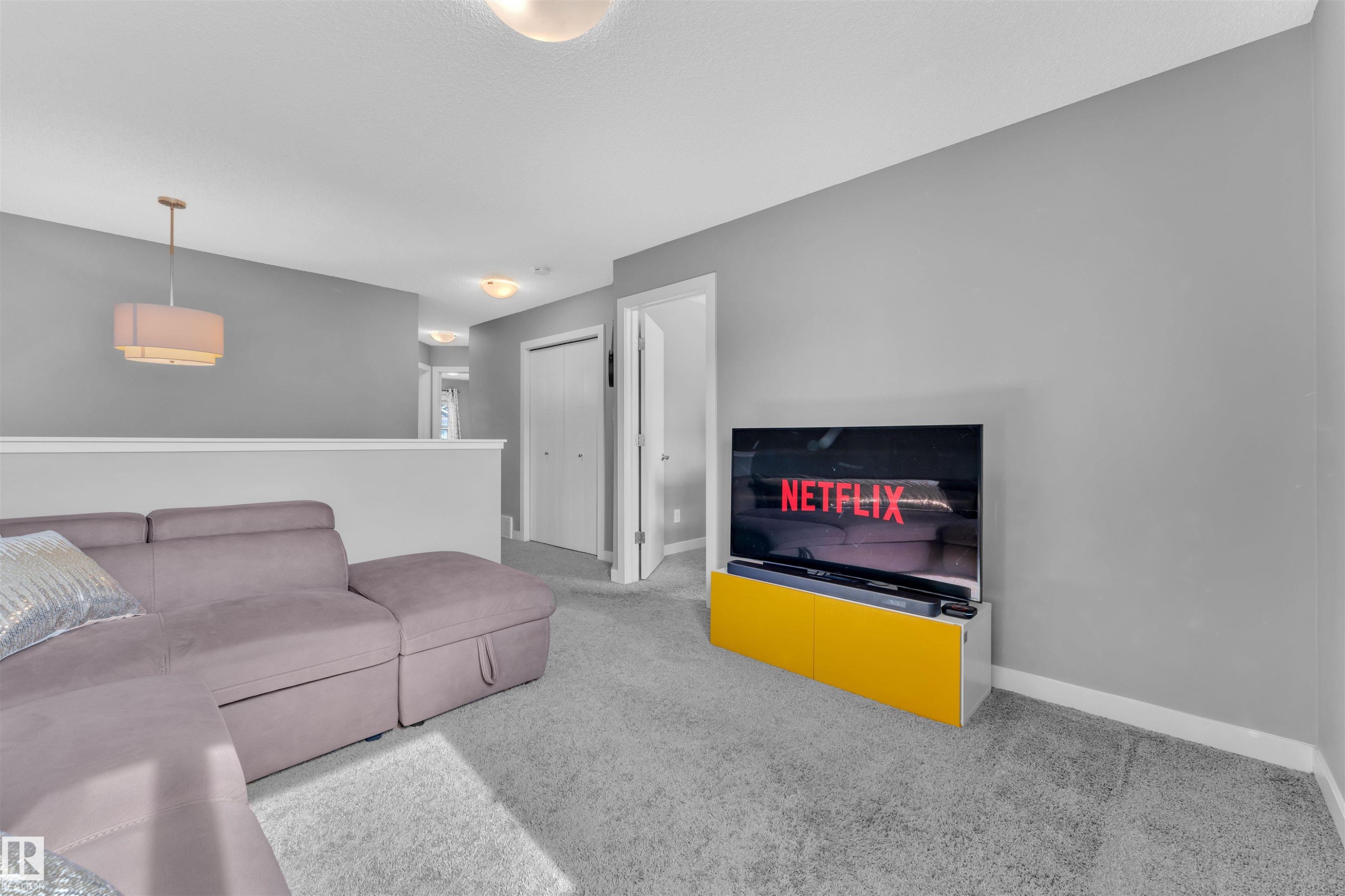 The property features light gray walls and gray carpeting, providing a neutral backdrop - 8108 217 Street, Edmonton, AB - Indoor