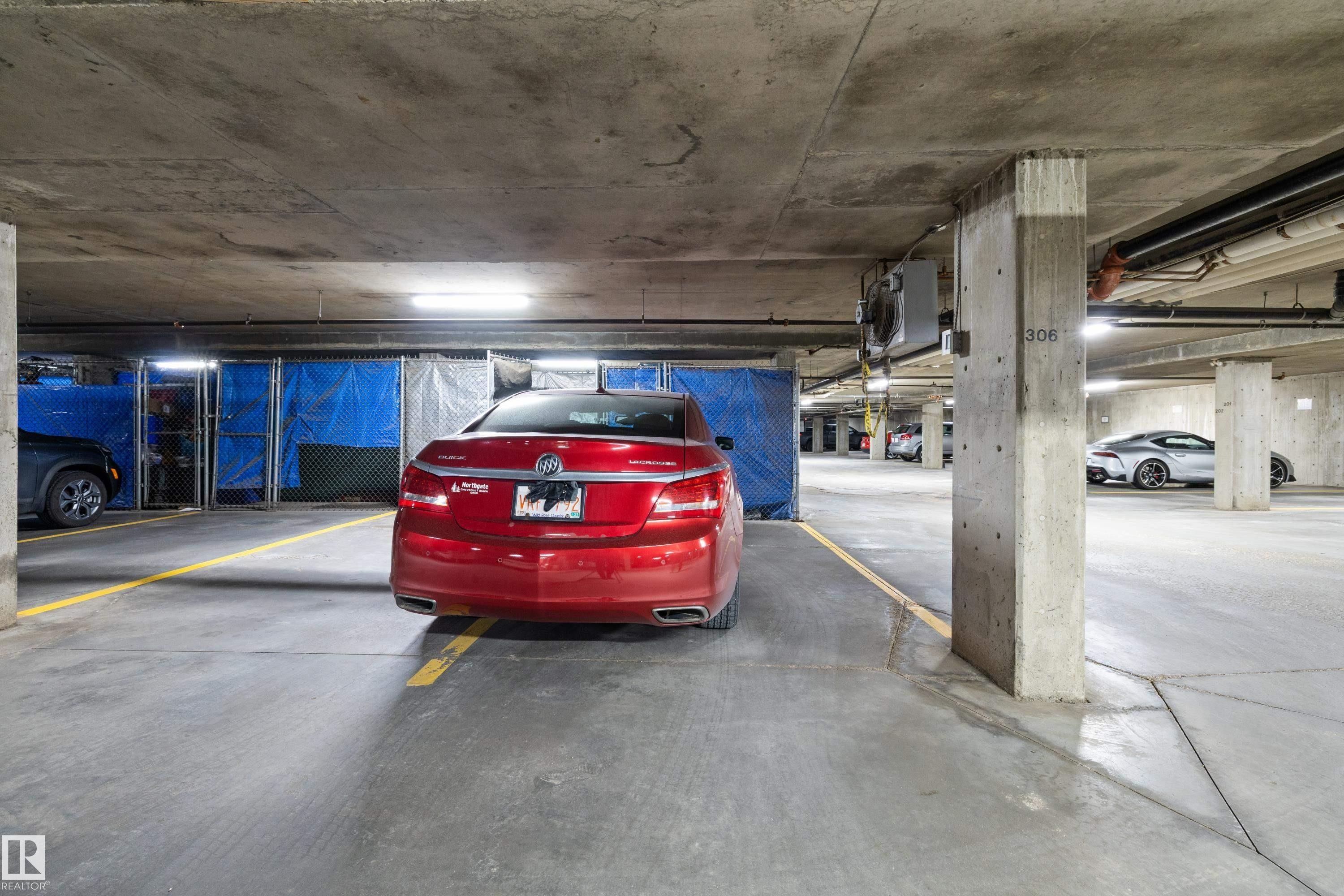 Secure underground parking garage featuring concrete pillars and exposed ceilings - 406 16035 132 Street, Edmonton, AB - Indoor Photo Showing Garage