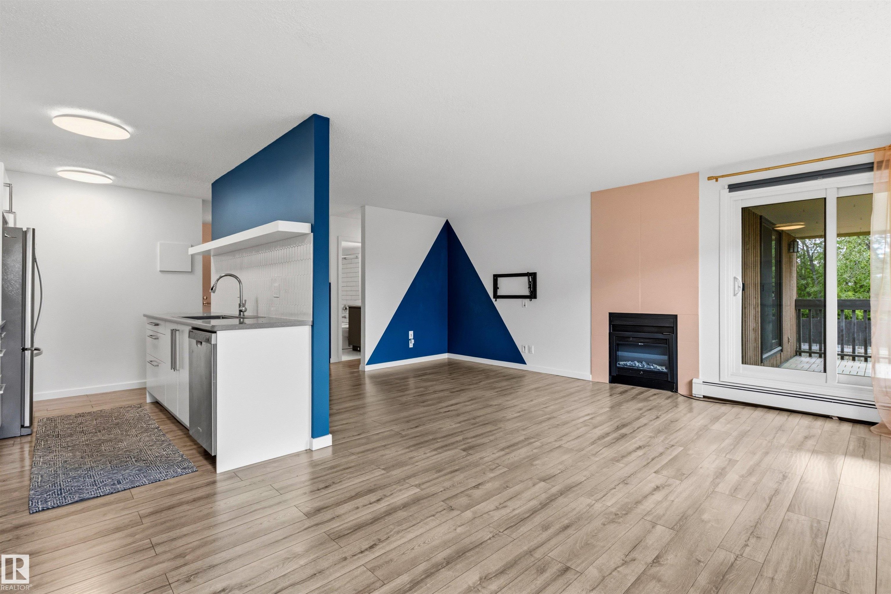Open-concept living area with wood-finish flooring - 217 14819 51 Avenue, Edmonton, AB