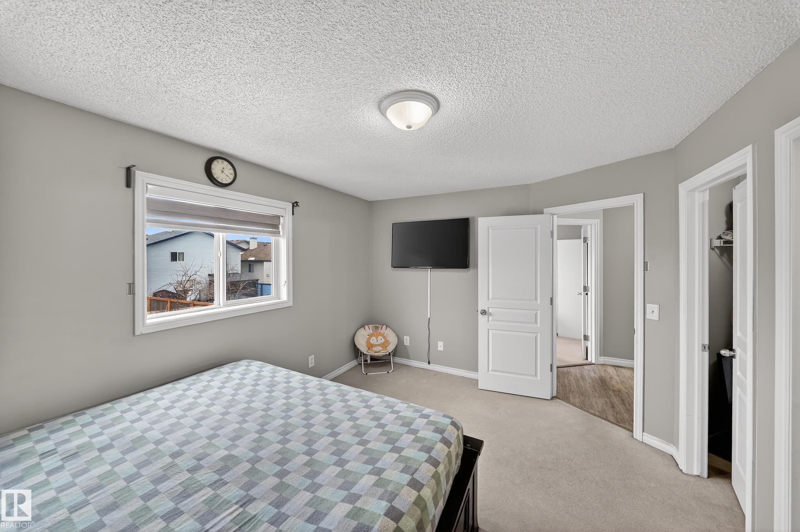This room features light grey walls and light-colored carpet, creating a bright atmosphere - 3517 25 Street, Edmonton, AB - Indoor Photo Showing Bedroom
