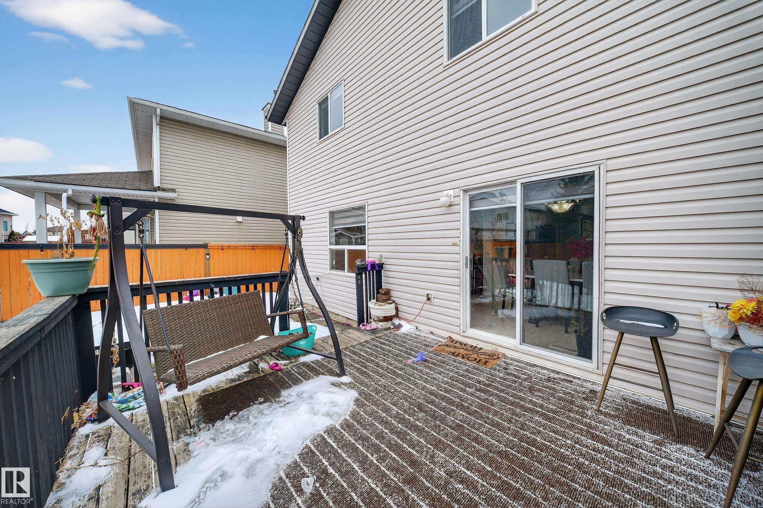 The property features a private deck with durable wood decking and a sliding glass door providing access to the interior - 3517 25 Street, Edmonton, AB - Outdoor With Exterior