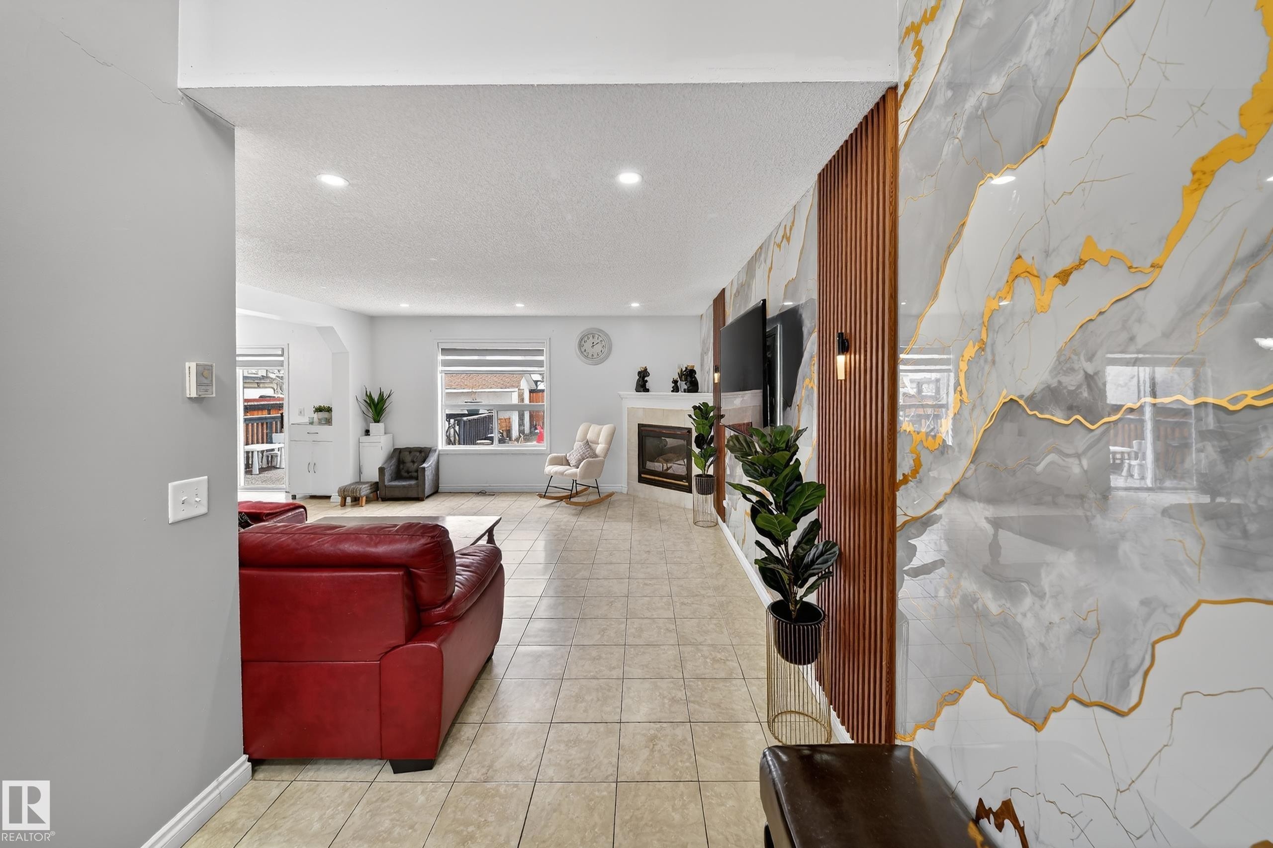 The living area features tiled flooring, recessed lighting, and a fireplace - 3517 25 Street, Edmonton, AB - Indoor Photo Showing Other Room