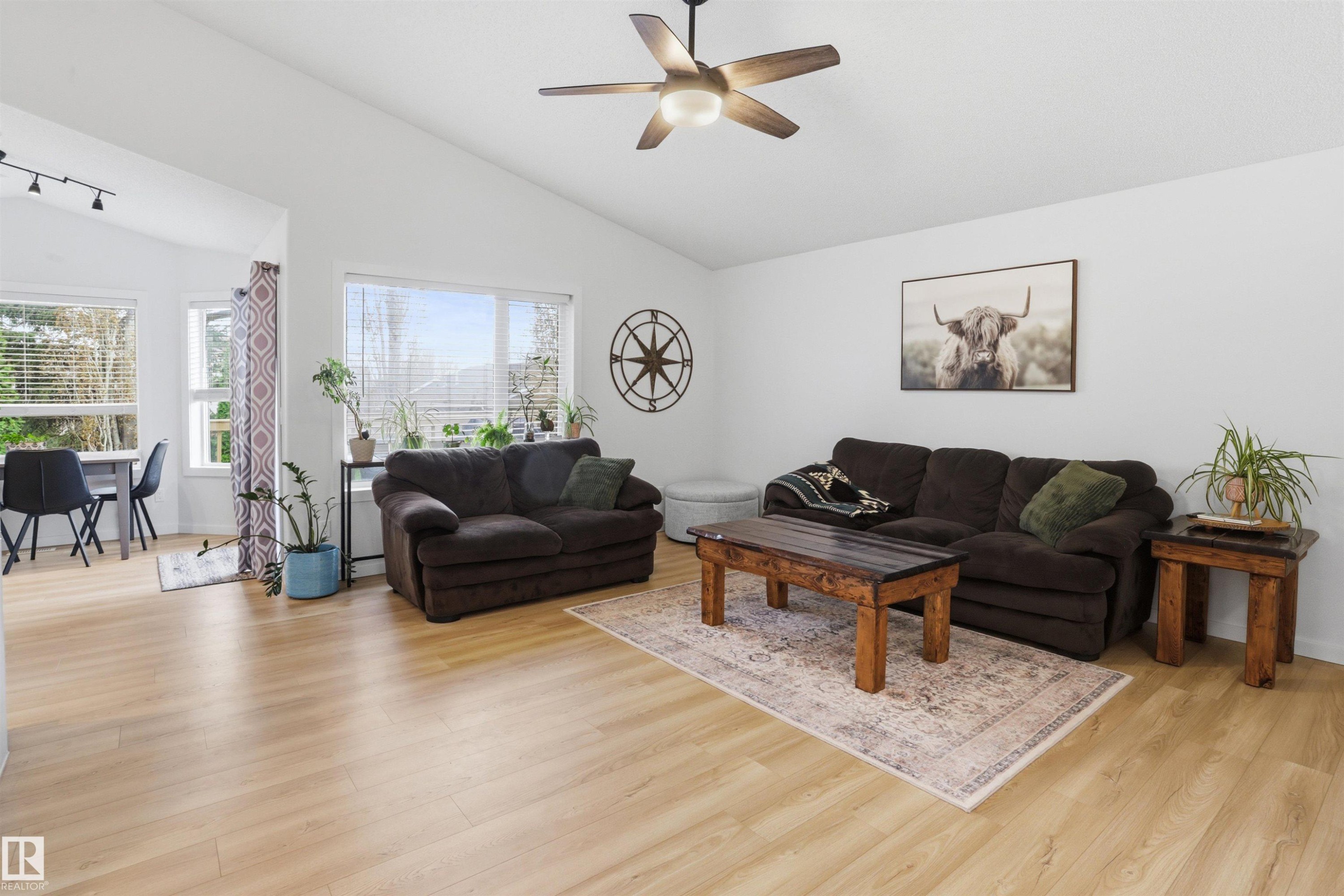 Living area featuring vaulted ceilings and light wood-finish flooring - 396 Kananaskis Way, Devon, AB - Indoor Photo Showing Living Room