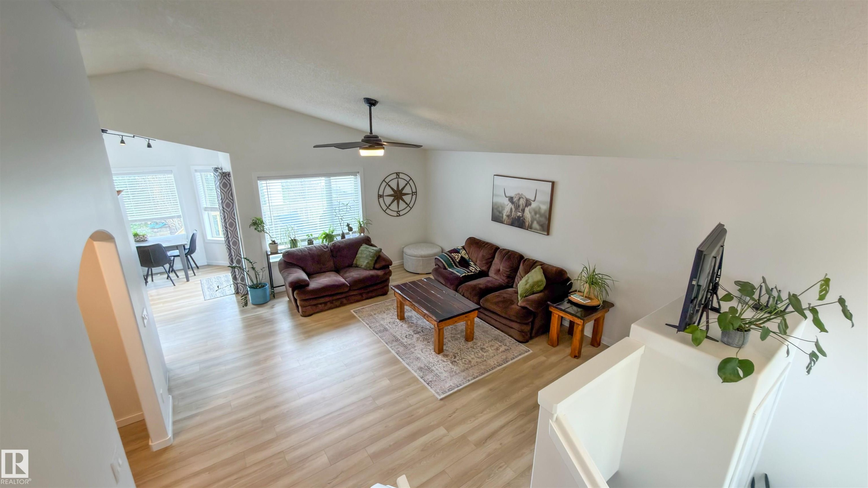 Vaulted ceiling with a ceiling fan and light fixture - 396 Kananaskis Way, Devon, AB - Indoor Photo Showing Living Room
