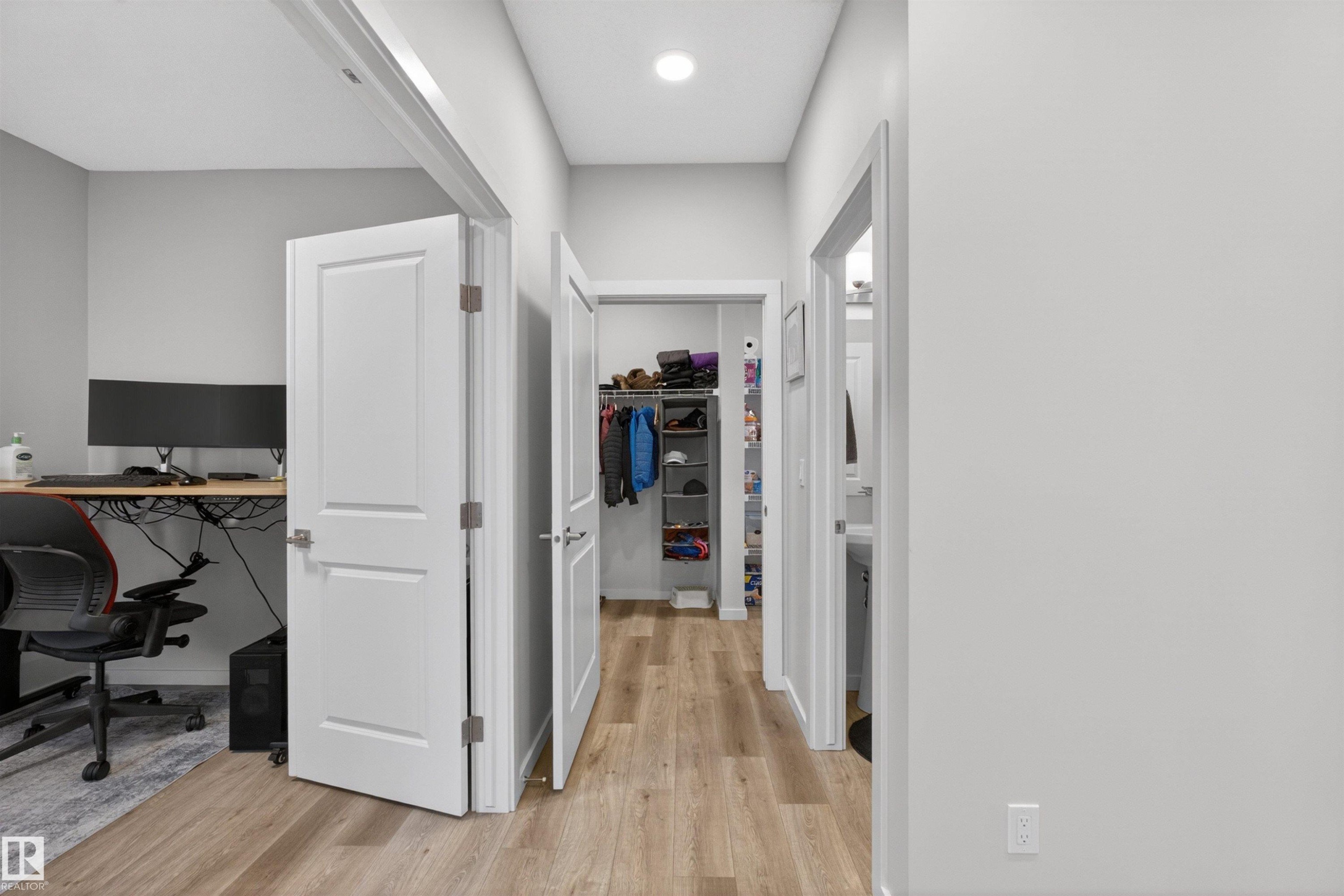 Hallway featuring wood-finish flooring, light grey walls, and recessed lighting - 332 Juniper Cove, Leduc, AB - Indoor Photo Showing Office