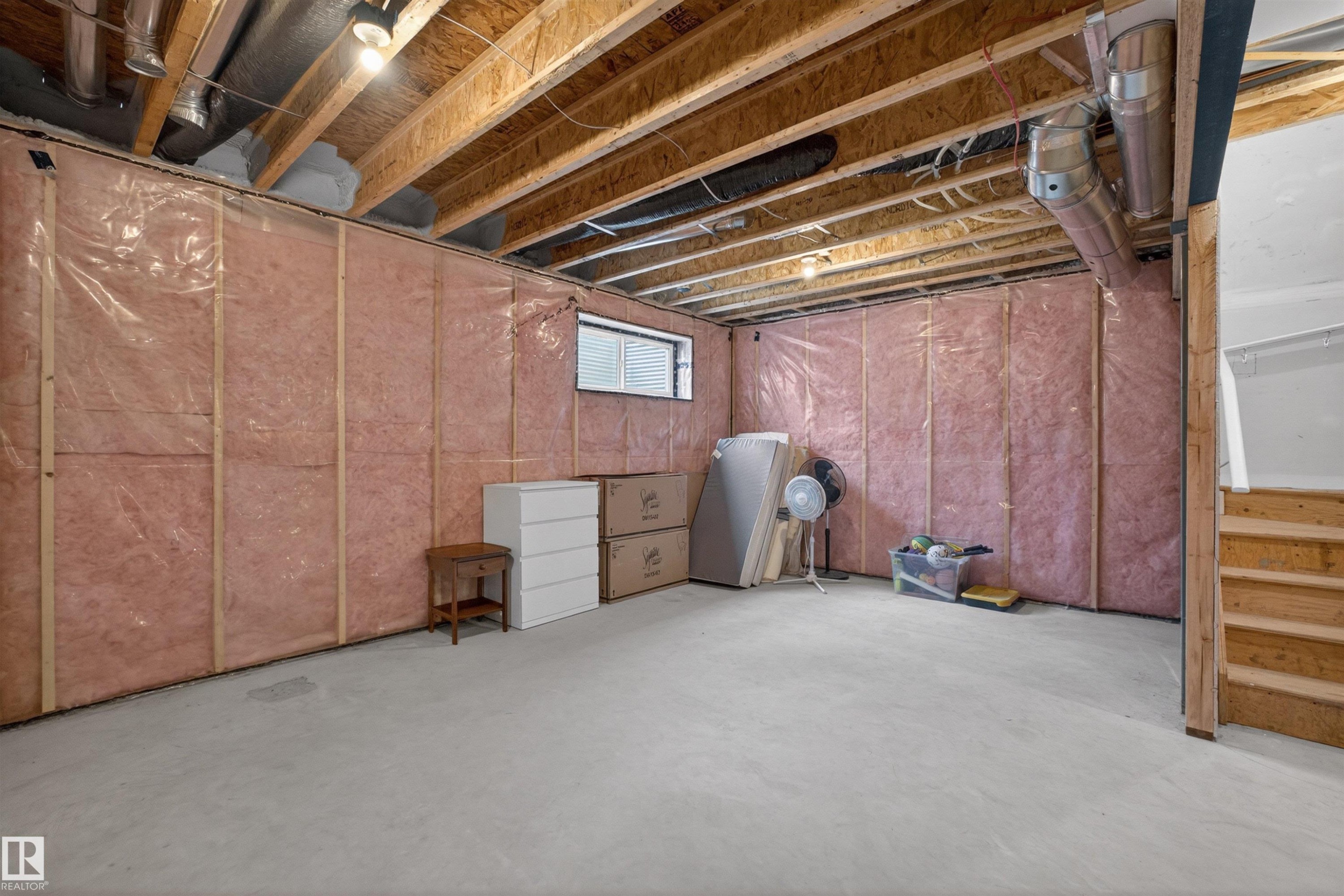 Unfinished basement with exposed ceiling joists and concrete flooring - 332 Juniper Cove, Leduc, AB - Indoor Photo Showing Basement