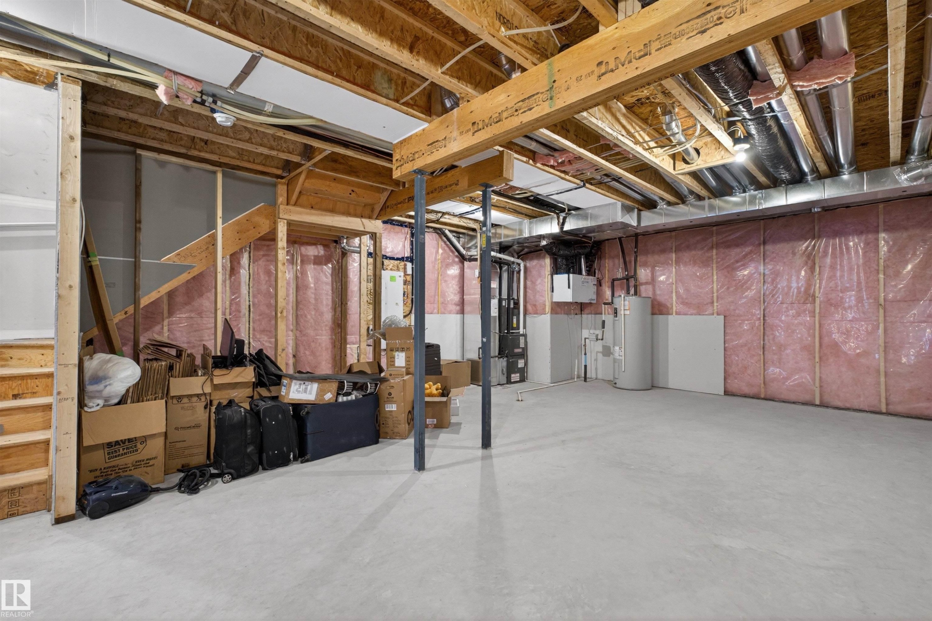 Unfinished basement featuring exposed wood joists, concrete flooring, and visible insulation - 332 Juniper Cove, Leduc, AB - Indoor Photo Showing Basement