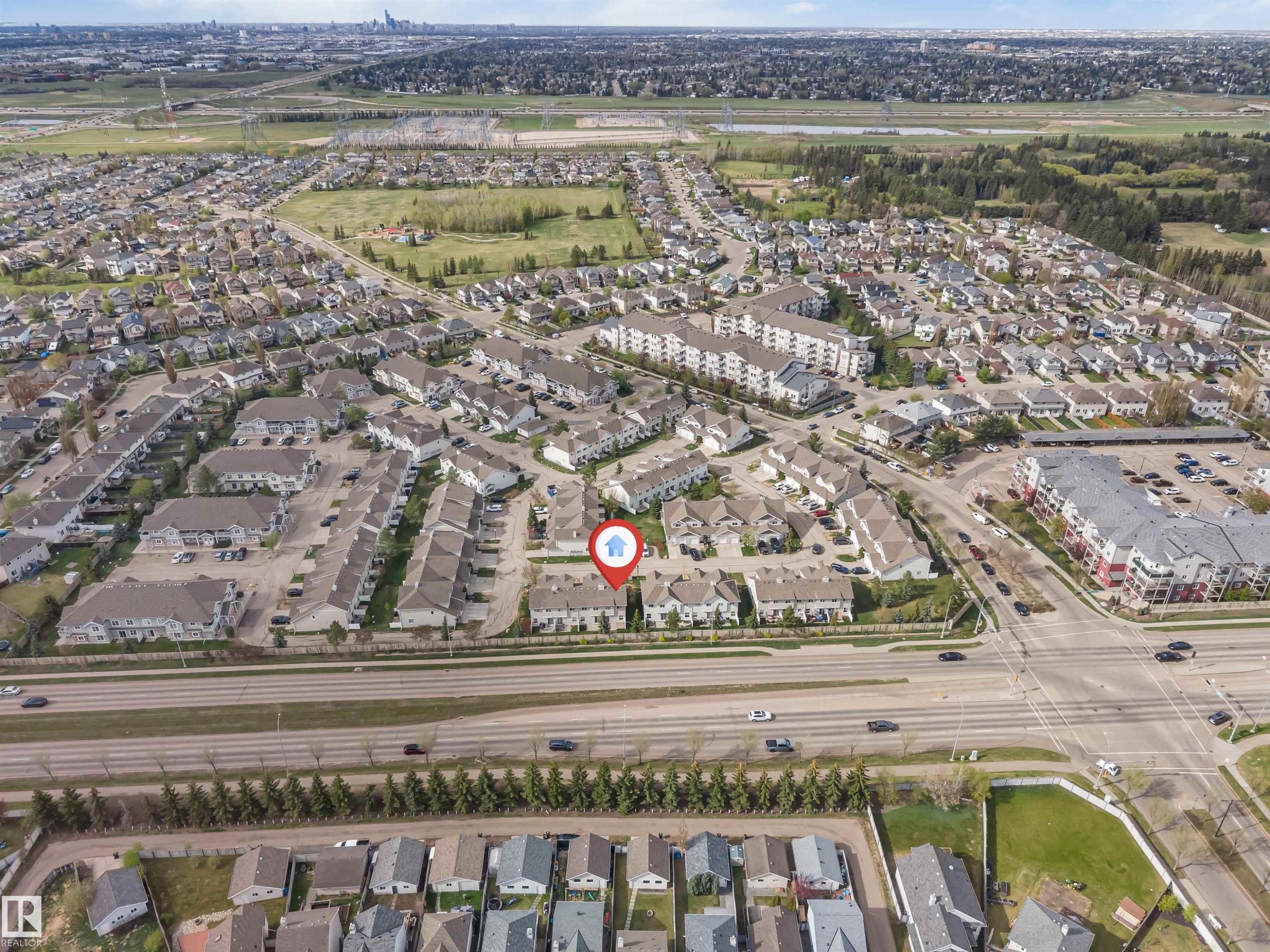 Aerial perspective showcasing a residential community with varied housing types - 135 150 Edwards Drive, Edmonton, AB - Outdoor With View